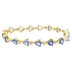 Llamativa pulsera de eslabones de oro amarillo de 14k con tanzanita y diamantes