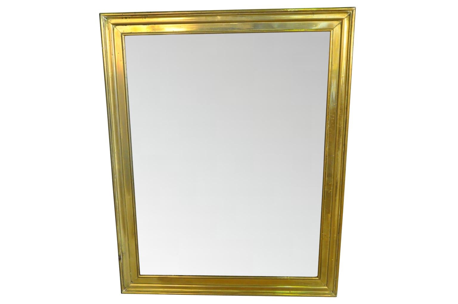 Un très beau miroir français de la fin du 19ème siècle en laiton magnifiquement moulé. Les lignes épurées de ce miroir lui confèrent un aspect très classique et contemporain. Le miroir conserve son verre au mercure d'origine et le dos est doublé de