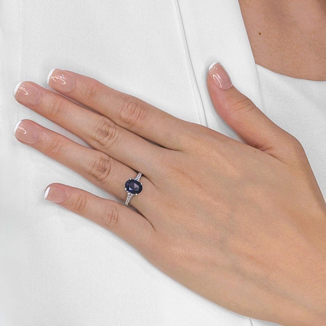 A true masterpiece of sophistication, this 18K white gold pave ring showcases a stunning 3.33ct unheated Ceylon sapphire, exuding a deep dark blue hue, known for its rarity and exceptional beauty. Surrounding this captivating centerpiece, 70 round