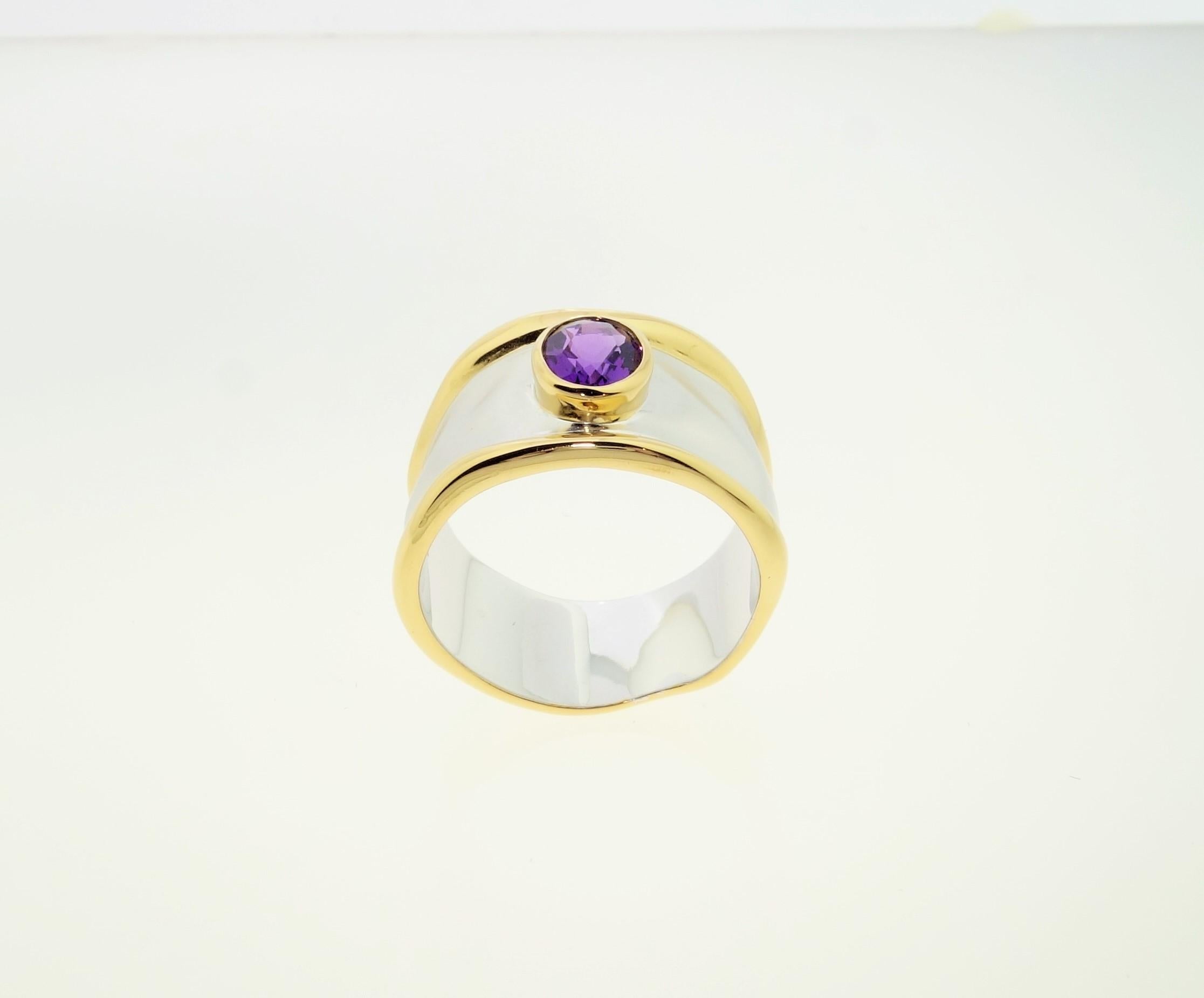 Beautiful Solitaire Cocktail Ring featuring an oval Amethyst; approx. 0.59 carat; approx. stone size: 6mm x 5mm. Sterling Silver Tarnish-resistant Rhodium and gold plated accents on either side of mounting. Size 7. Classic and Chic…illuminating your