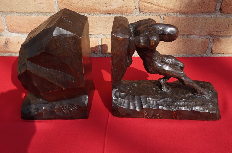 Impressive and stylized strongman bookends, hand carved out of one block of wood.

The artist who made these abstract and wonderful bookends has perfectly captured the natural posture of a man pushing his back against an object. The stylized