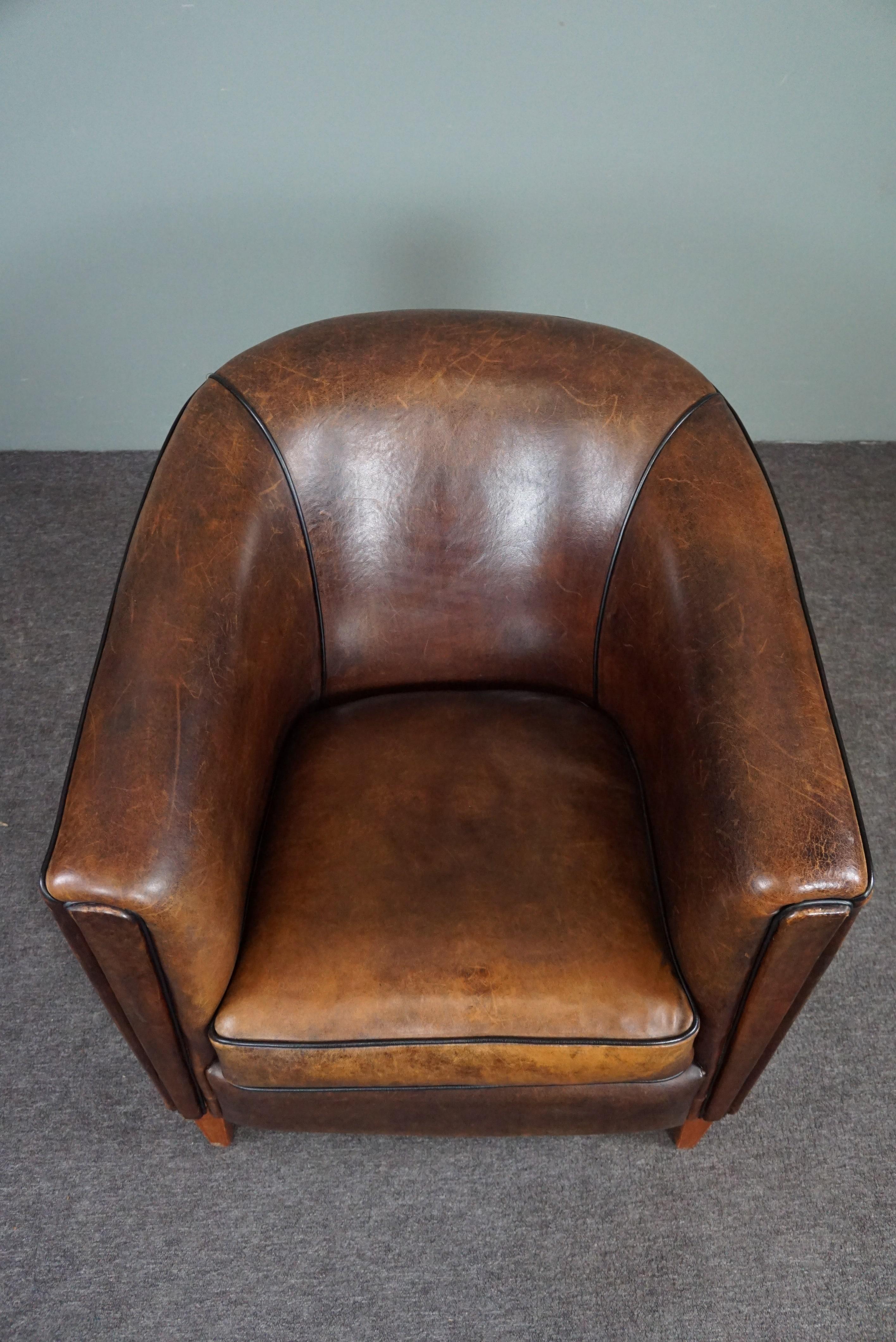Contemporary Striking and sleekly designed sheep leather club armchair For Sale