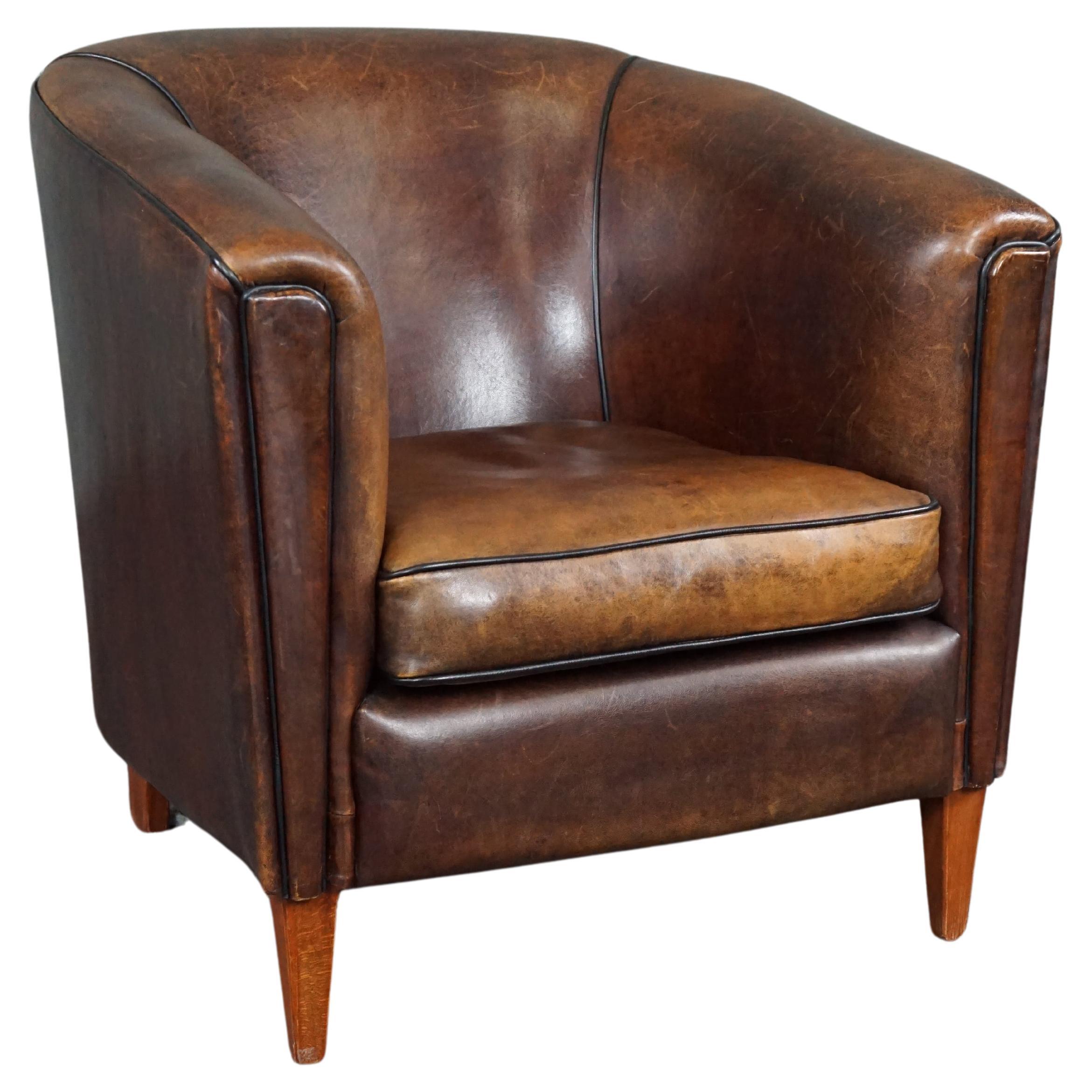 Striking and sleekly designed sheep leather club armchair For Sale