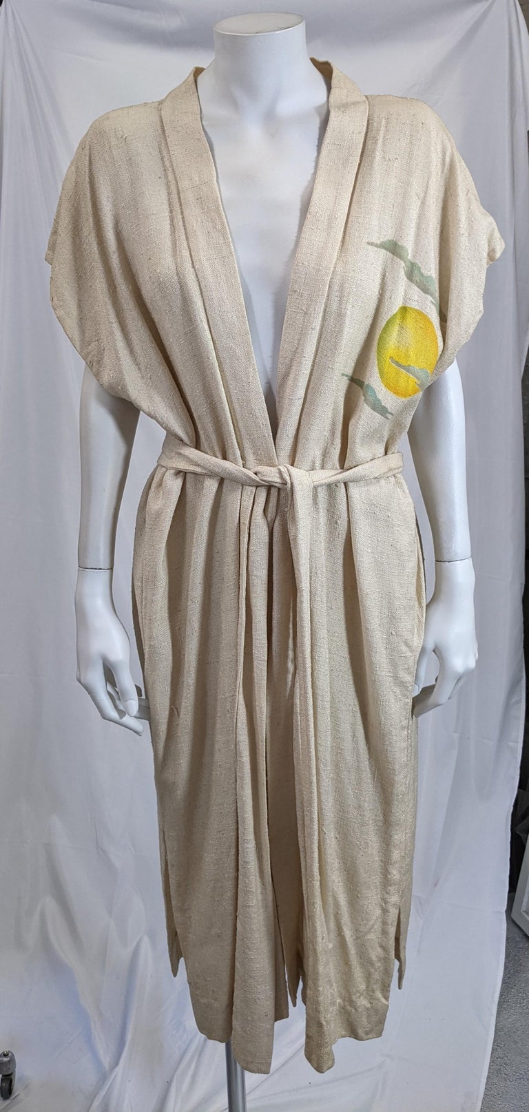 Striking and unusual Art Deco lounging robe of simple rectangular shape with self belt, in raw silk tussah. The garments' back is stenciled and air brushed with a Deco Modernist figure of a female warrior against a full moon. The front has a motif