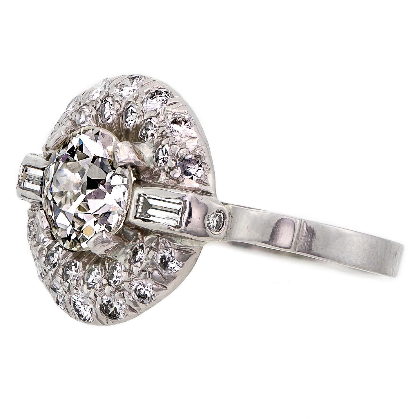 Eye-catching Art Deco platinum and diamond lady's ring containing one (1) dazzling prong set Old European Cut diamond surrounded by twelve (12) sparkling pave set single cut diamonds encircled by a row of fourteen (14) round brilliant cut diamonds