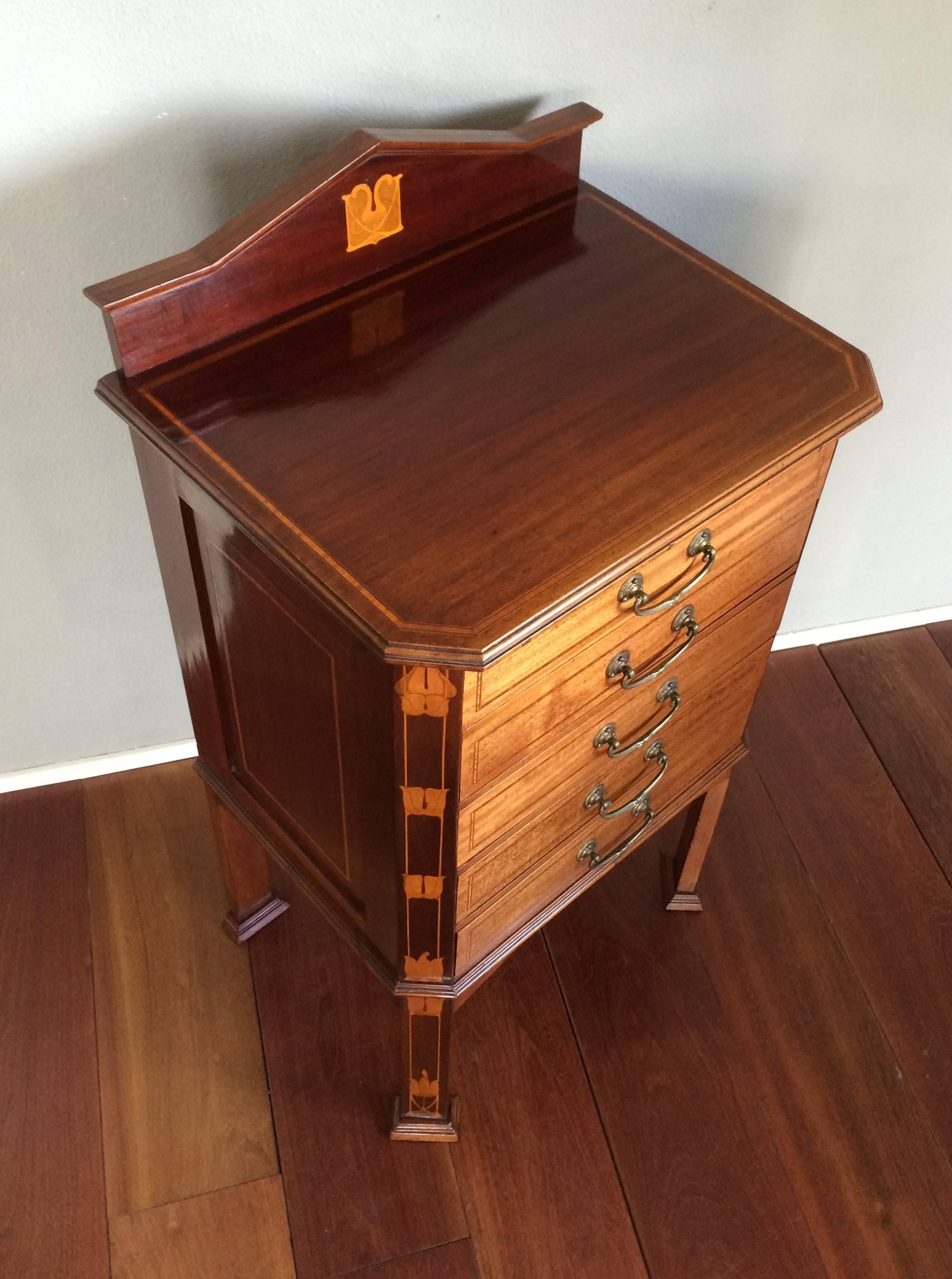 Beautifully designed AND executed filing cabinet with special drawers.

We could hardly believe our eyes when we first saw this rare and stunning little filing cabinet from the heydays of the British Arts and Crafts period. The first thing that