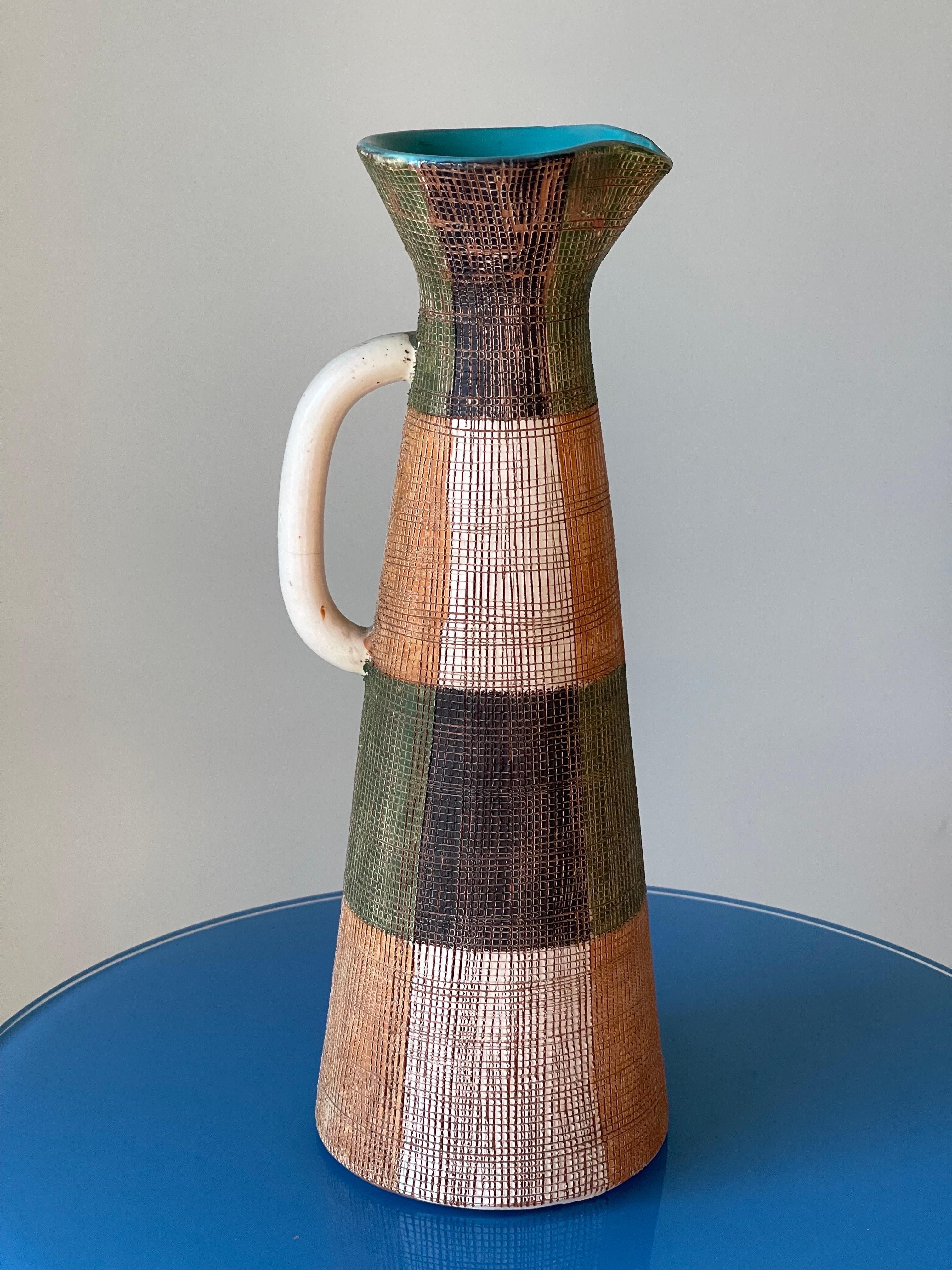 Eye catching Italian Ceramic Pitcher by Bitossi in “Seta” glaze for Raymor - 1960’s. Excellent condition with a little glaze loss spot on the top rim that was done when making this in the kiln. 13 x 4.5.