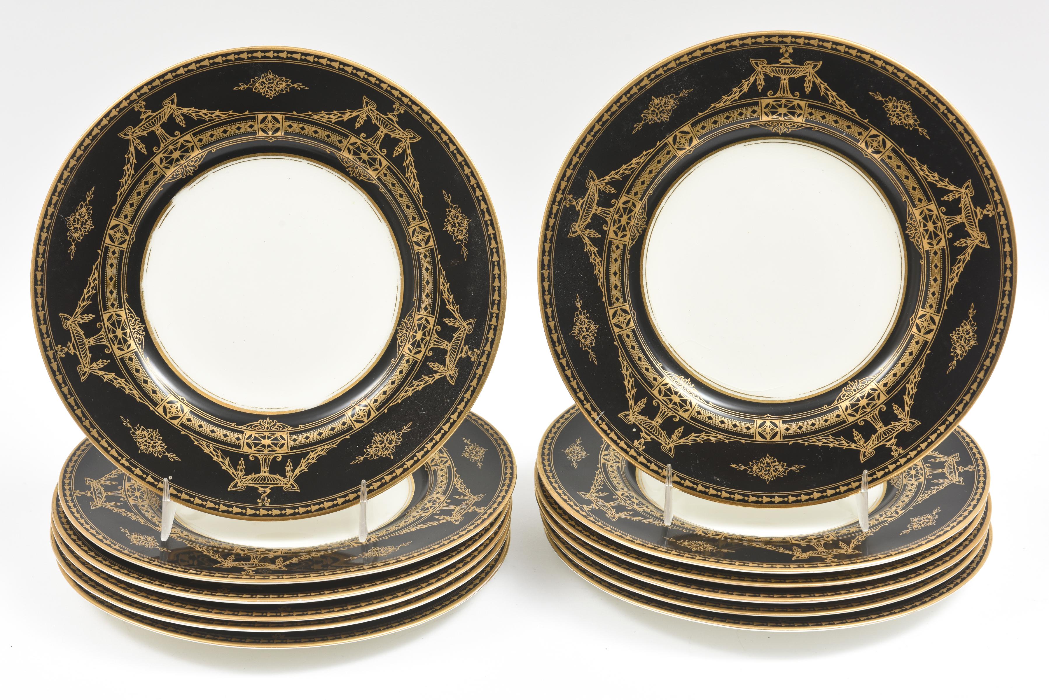 A fine and formal hard to find black ground fine china dessert service from one of England's oldest and finest manufacturers: Royal Worcester. This unique set features a 24 karat gilt neoclassical style pattern of urn and intricate swag motif on a