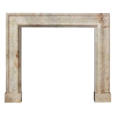 Striking Bolection Fireplace in Crema Marfil Marble