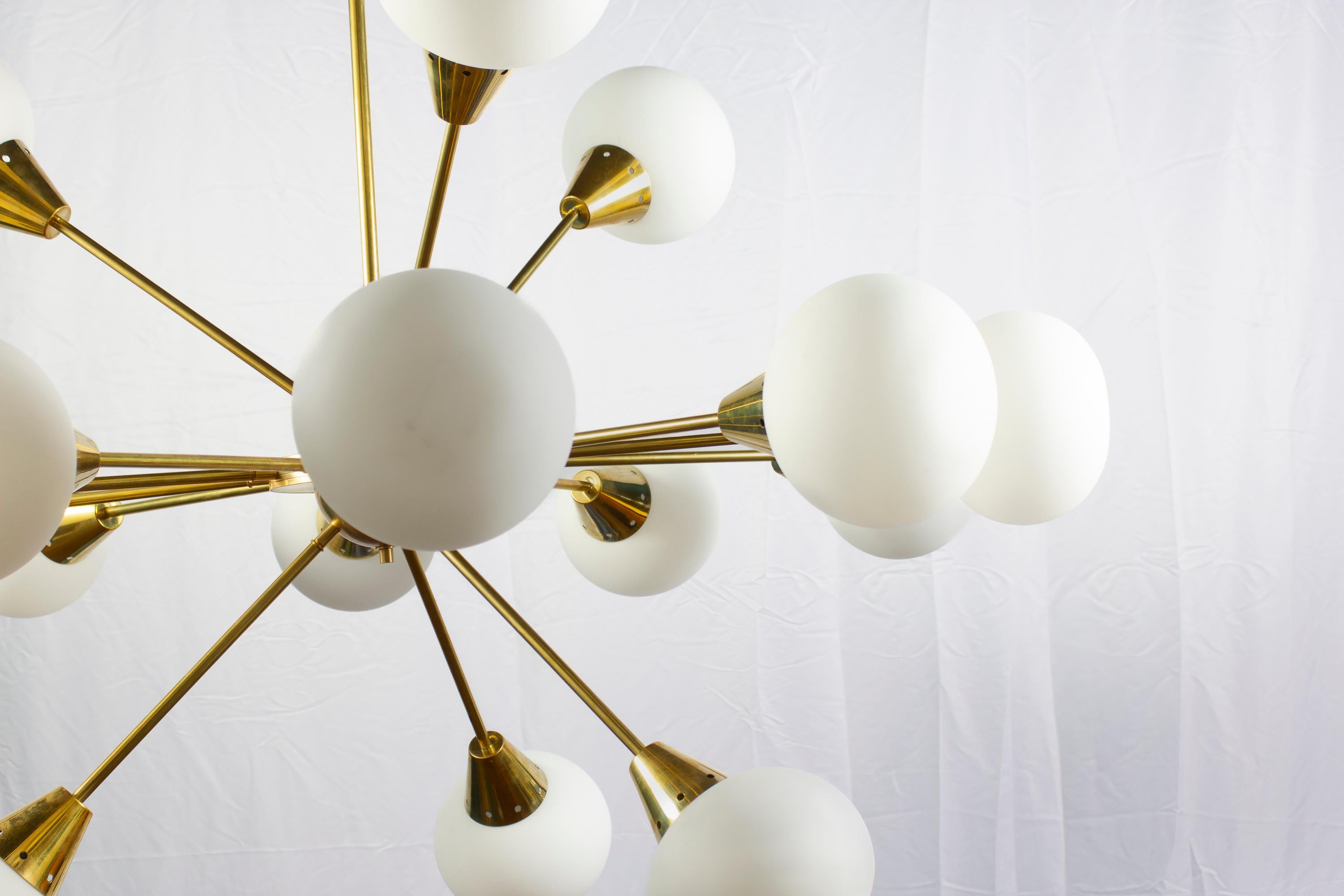 Extraordinary Italian midcentury brass and 16 opaline sphere Murano glass large Sputnik chandelier.
Available also a pair. The brass height is customizable.
16 E27 light bulbs.
This light fixture can be disassembled and the glasses individually