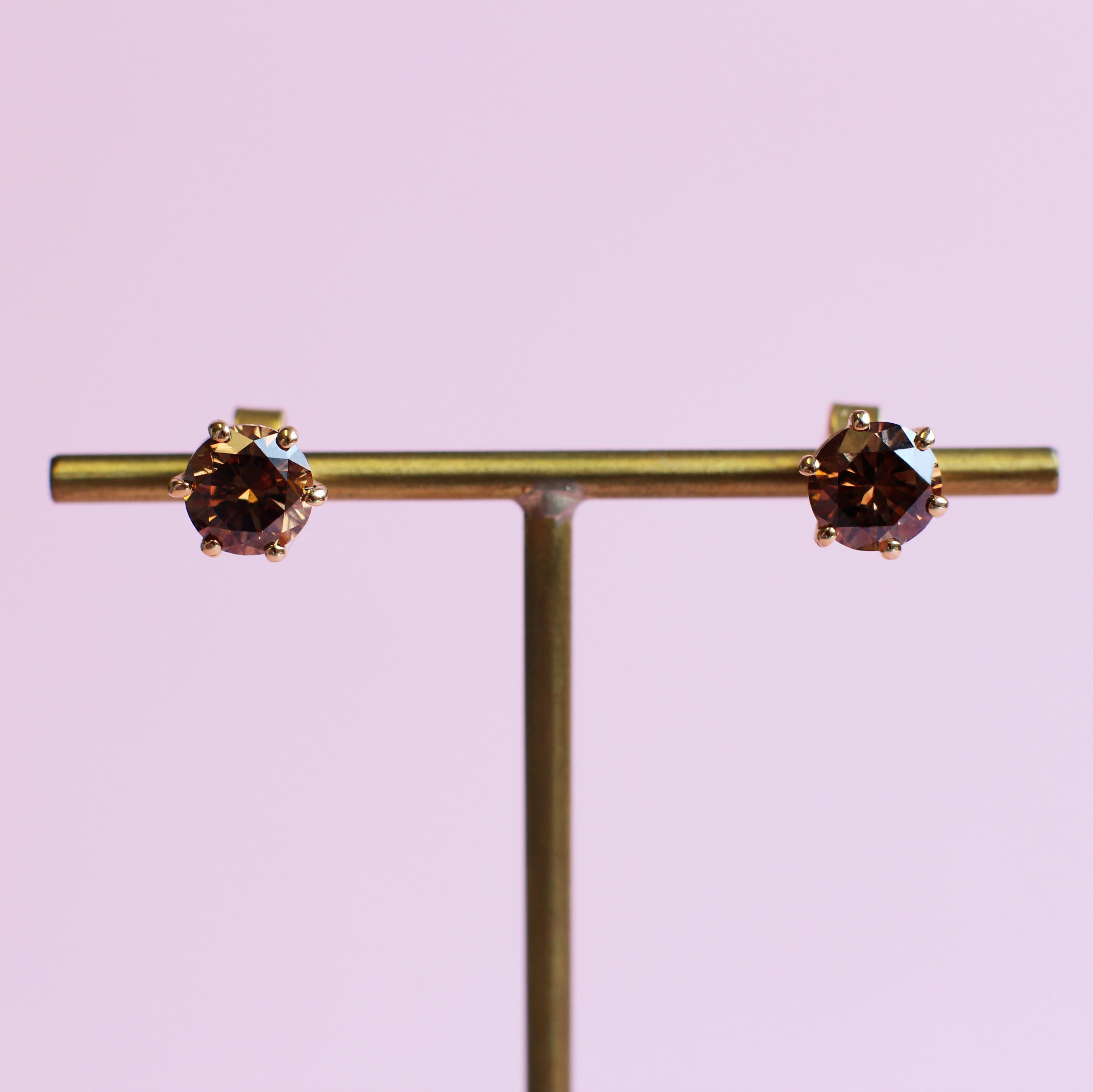 The intense, nutty tones of these fancy brown diamonds make these simple stud earrings something special. The stones were selected from the Haruni vault and are featured in a round-cut, with their yellow gold setting perfectly complementing their