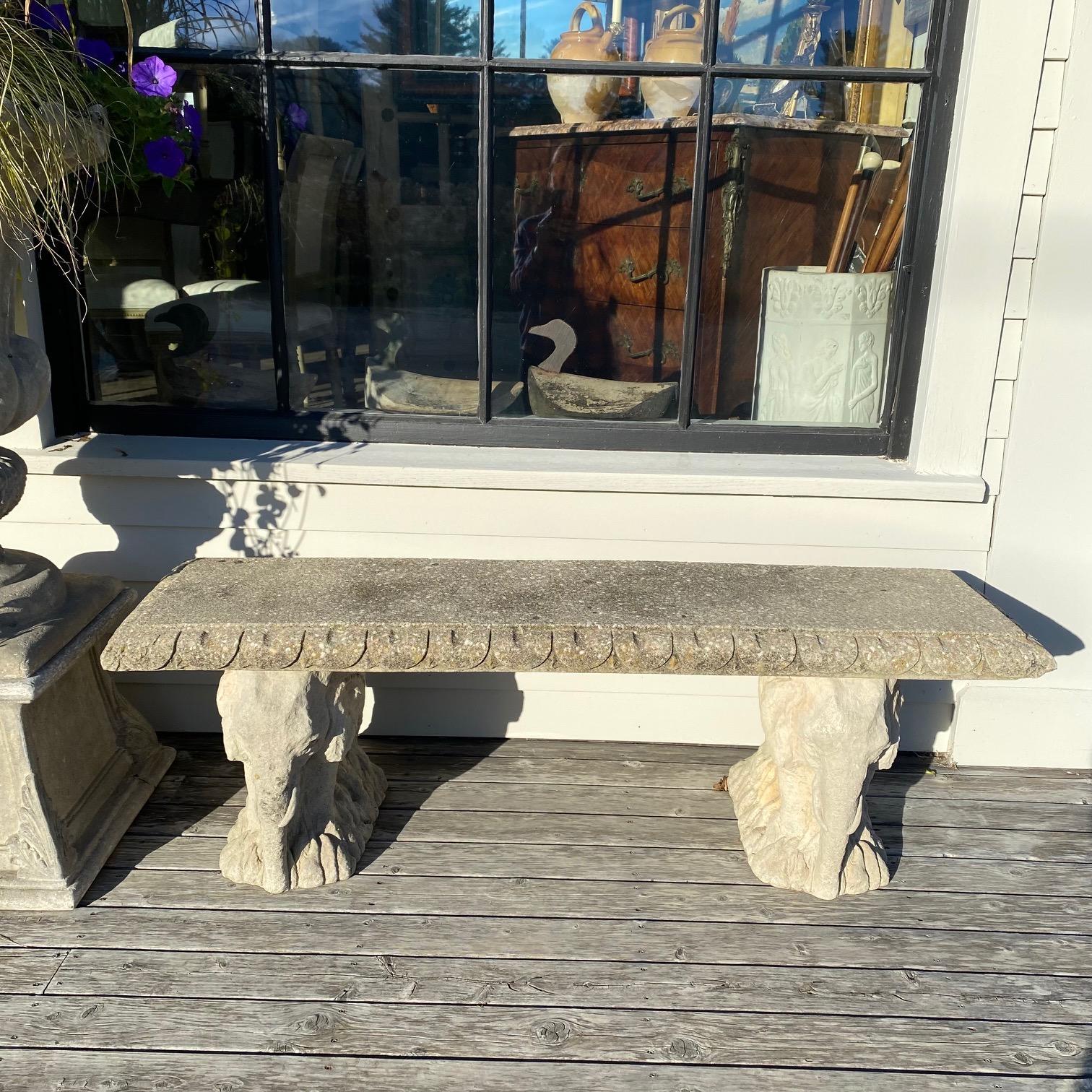 A cast stone seat with edge detail rests atop a pair of lovely cast stone supports in the shape of elephants. 
Note: A matching bench is available to make a pair, with lion base supports.

