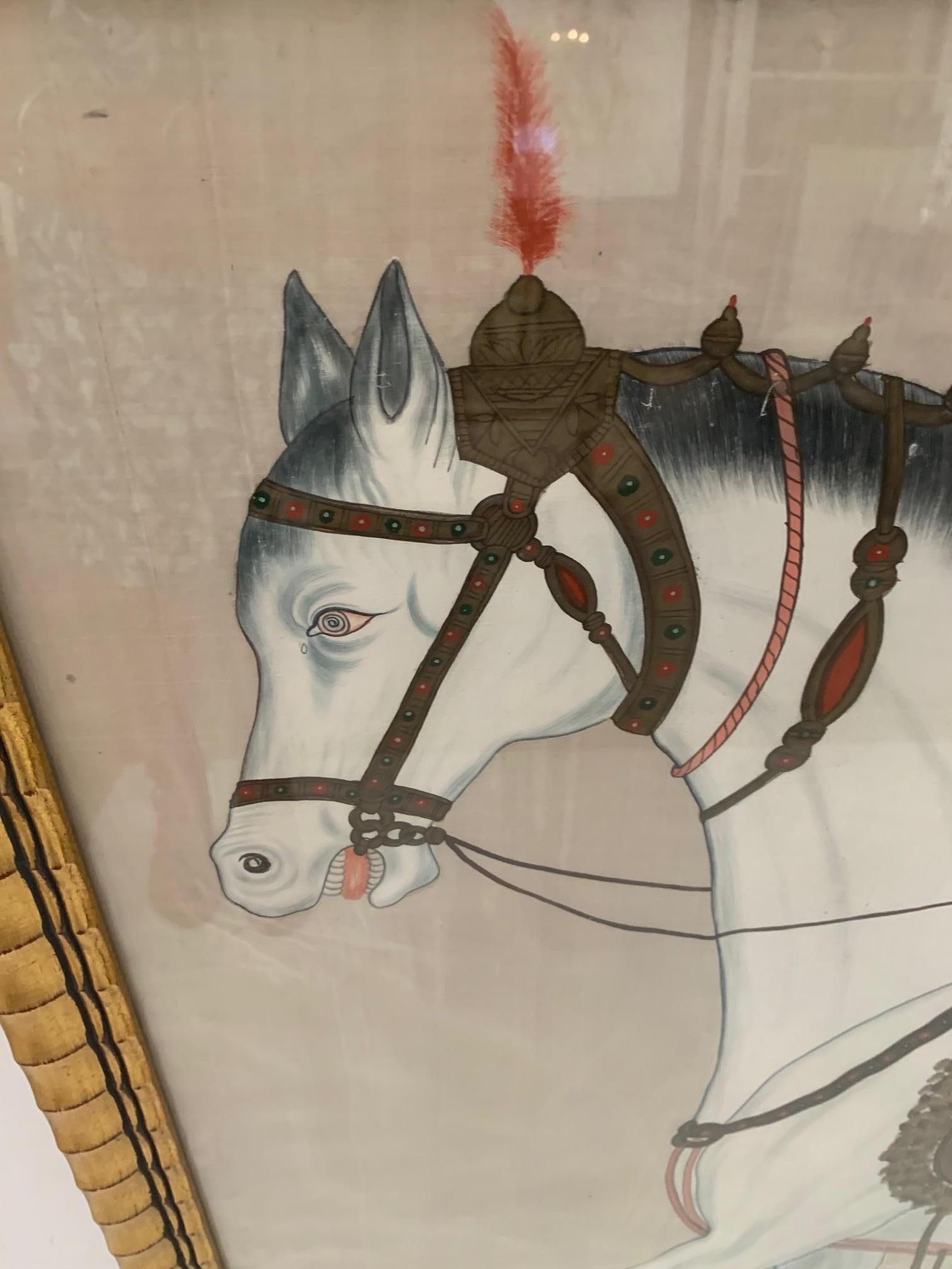 A gorgeous and graphic Chinese painting on champagne silk of a white Tang horse with fancy saddle. The frame is giltwood and compliments the art beautifully.