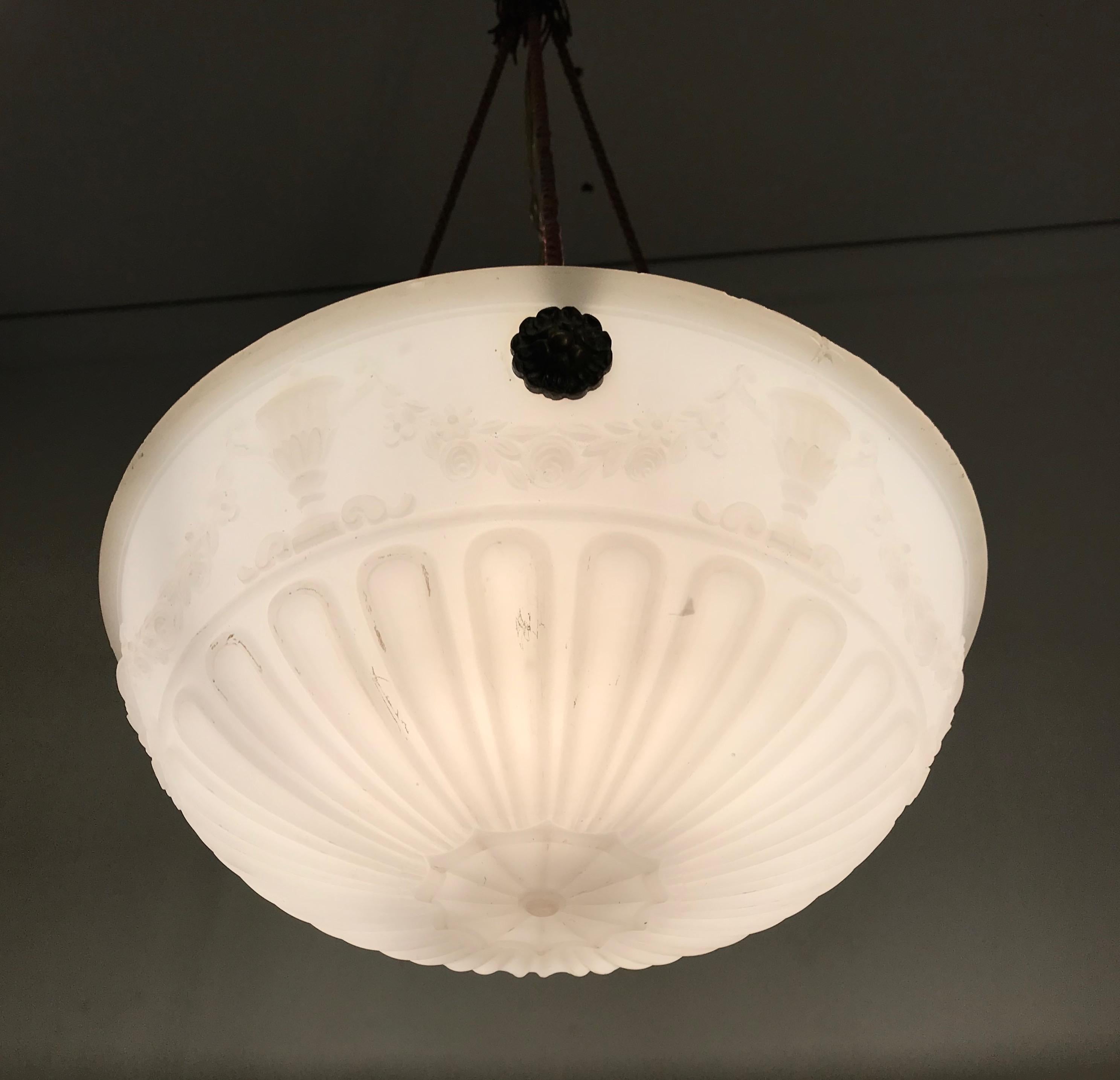 Stylish and practical size 1920s ceiling lamp.

This rare and thick glass shade pendant comes with a number of striking, neoclassical features that make this wonderful light fixture an absolute joy to own and look at. Especially with the light