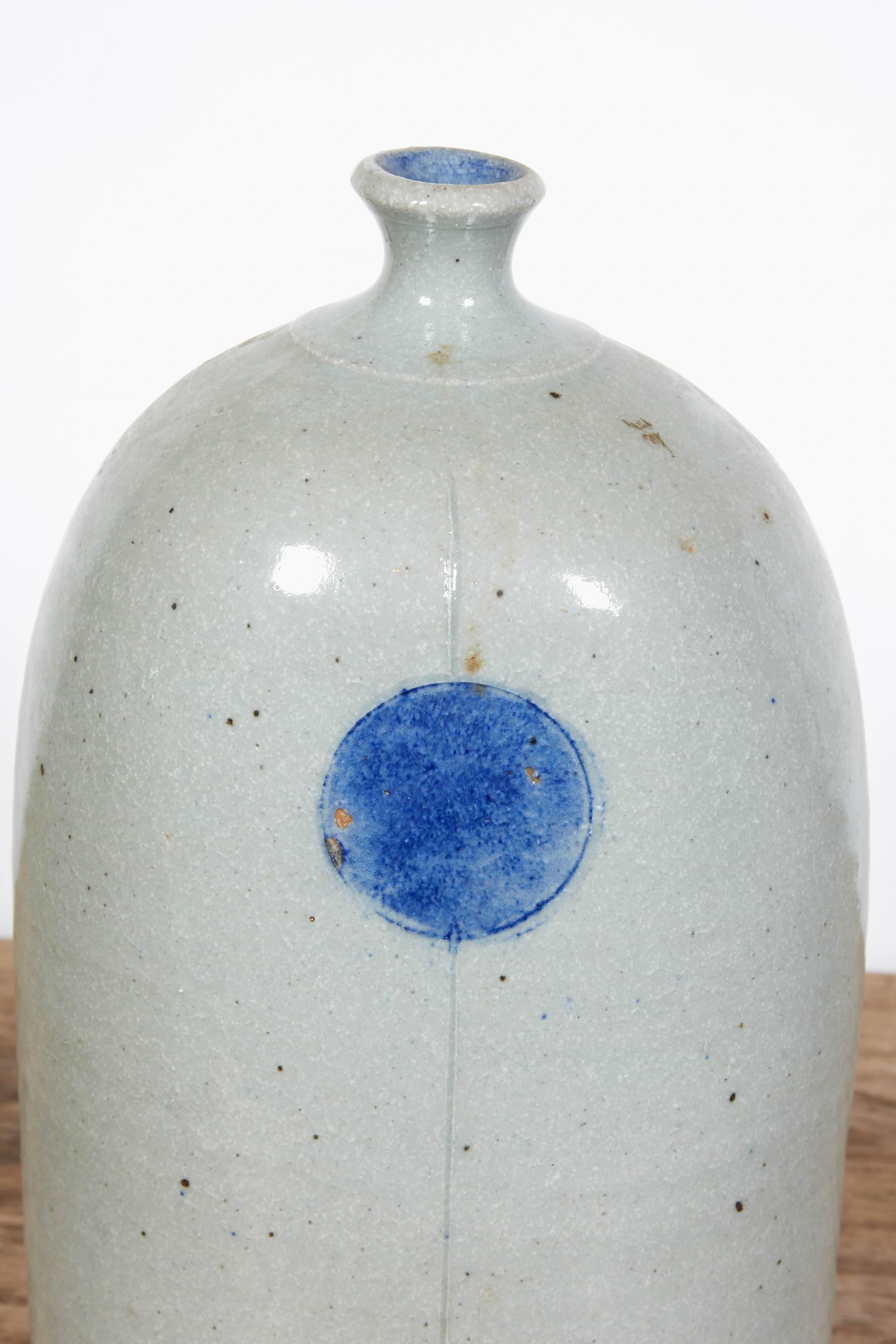 A simple and striking handmade and hand glazed ceramic vase with minimalist shape and warm colors.