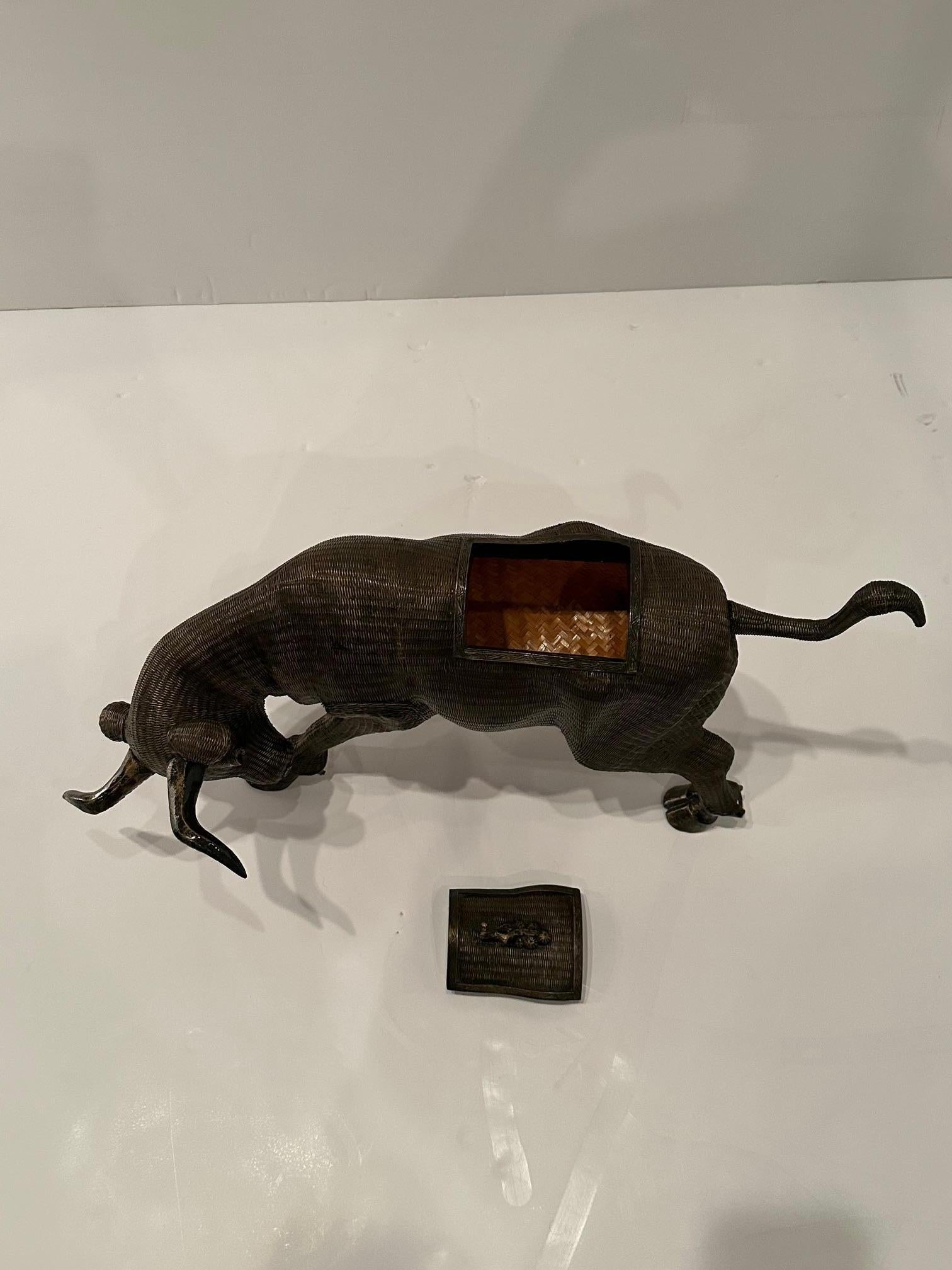 Masculine sculptural rattan box that has an opening at the top so it can function as a box.