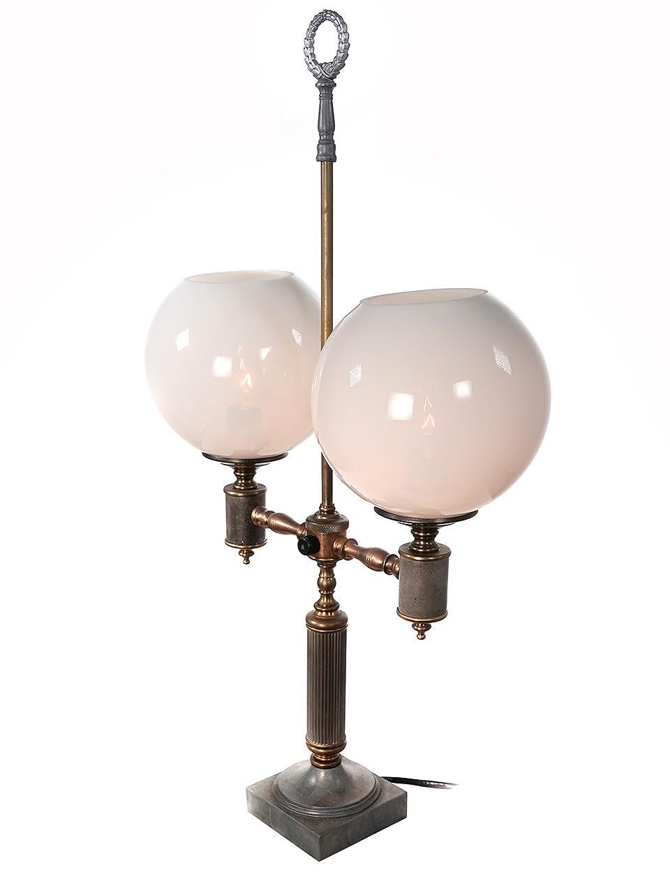 This desk lamp has just the right look. It illuminated by two 7 inch diameter heavy glass globes that look to me like Vaseline or warm colored Opaline glass. It spreads an nice warm and even light.