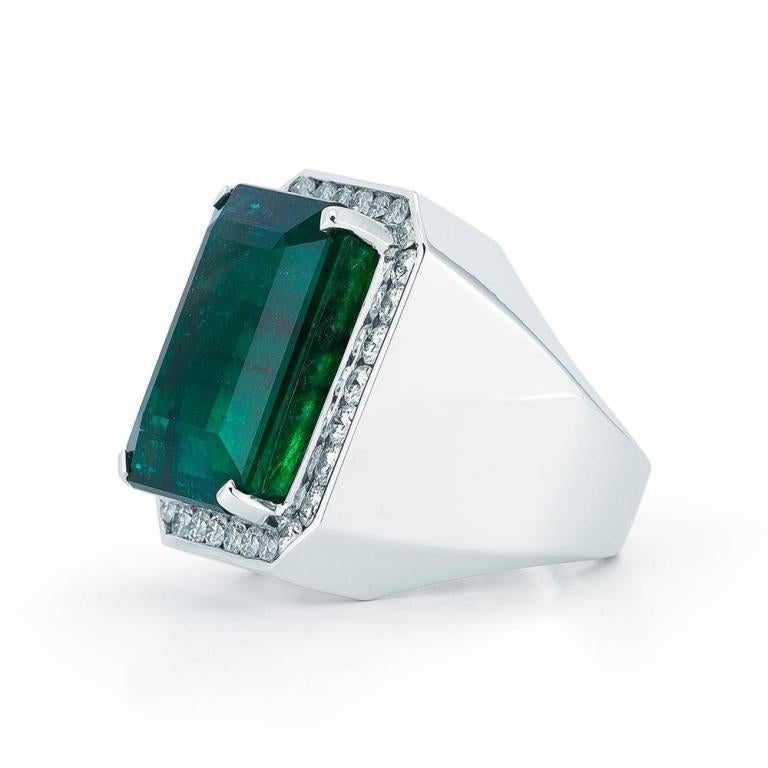 STRIKING EMERALD RING An impressive architectural white gold setting with diamond halo for the most discerning gentleman. Item: # 01827 Metal: 18k W Lab: Gia Color Weight: 44.82 ct. Diamond Weight: 4.56 ct.

