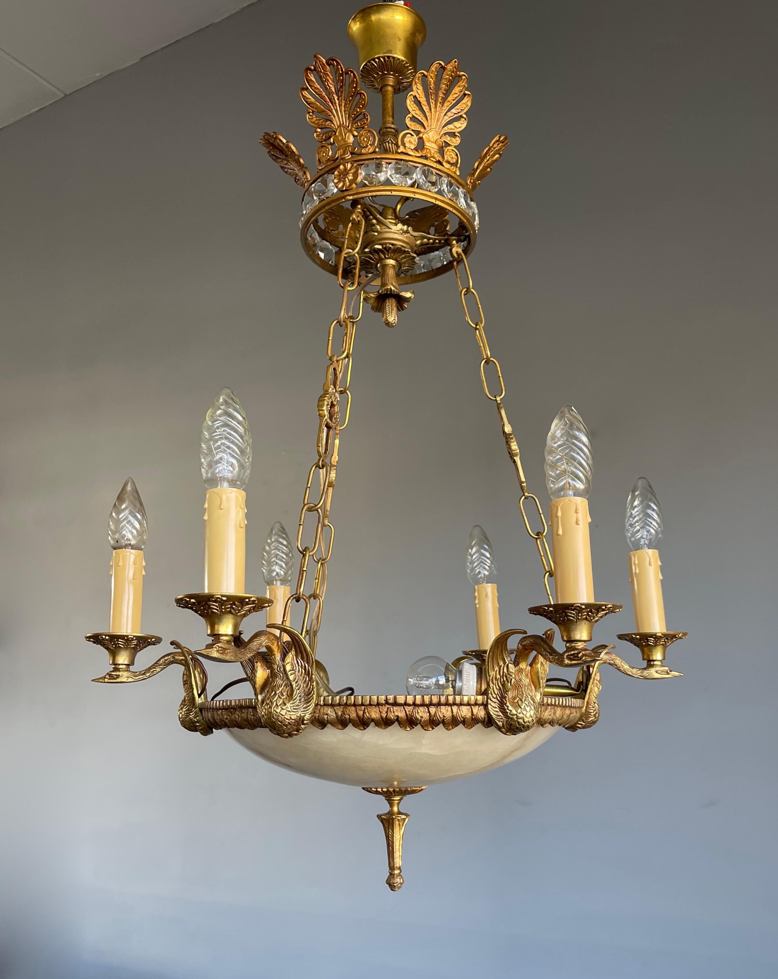 Stunning little 7-light chandelier with gilt bronze swan sculptures.

If you are looking for a truly stylish, well proportioned and finest quality light fixture then this circa 1940s work of lighting art could be perfect for you. The overall design,