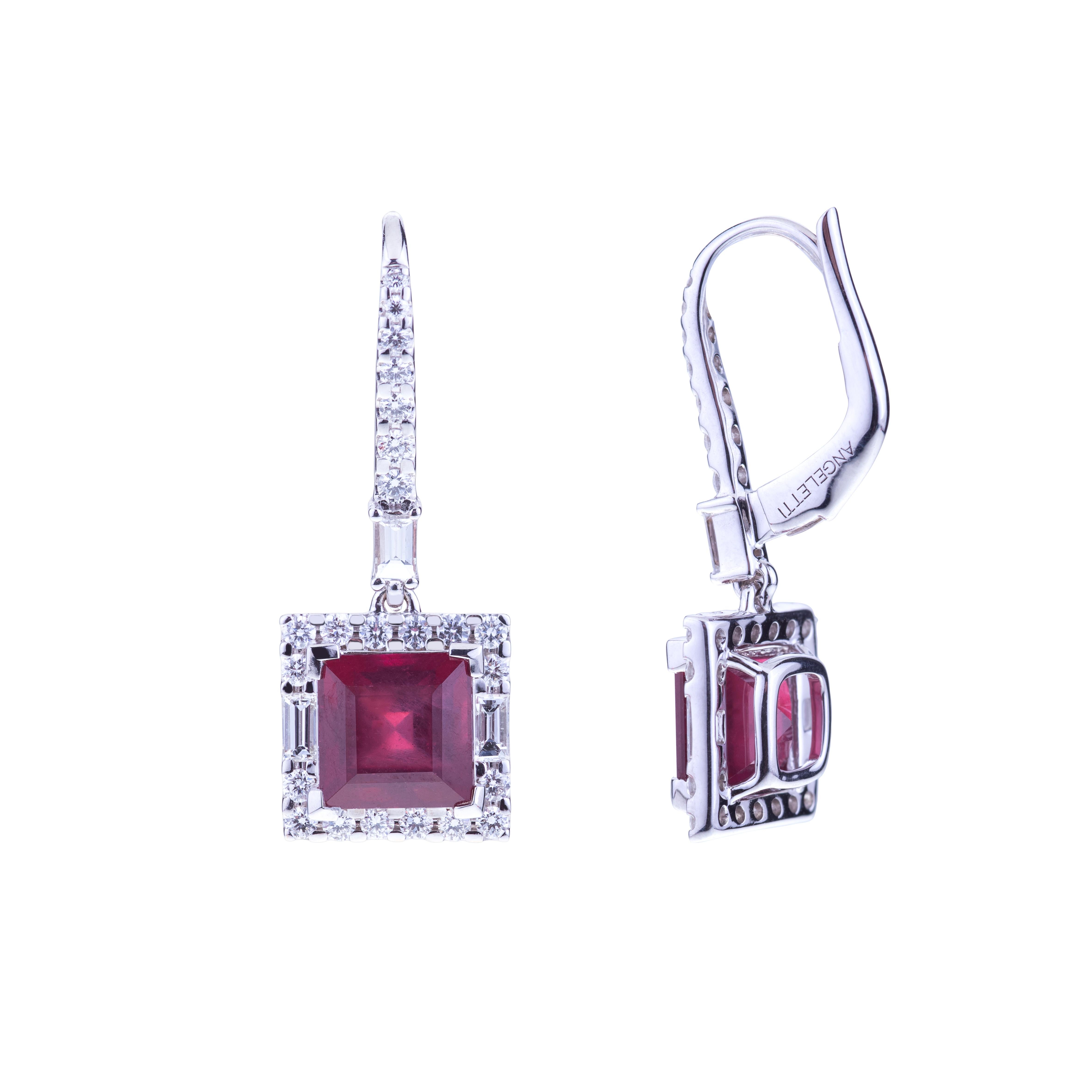 Striking Faceted Squared Ruby Earrings with a Royal Symmetry of Diamonds setting.
The Shape, albeit simple, refers to the Jewels Made by the Art Déco Masters, a Sophisticated Creation with Chromatic Contrasts, in particular Between the Red and the