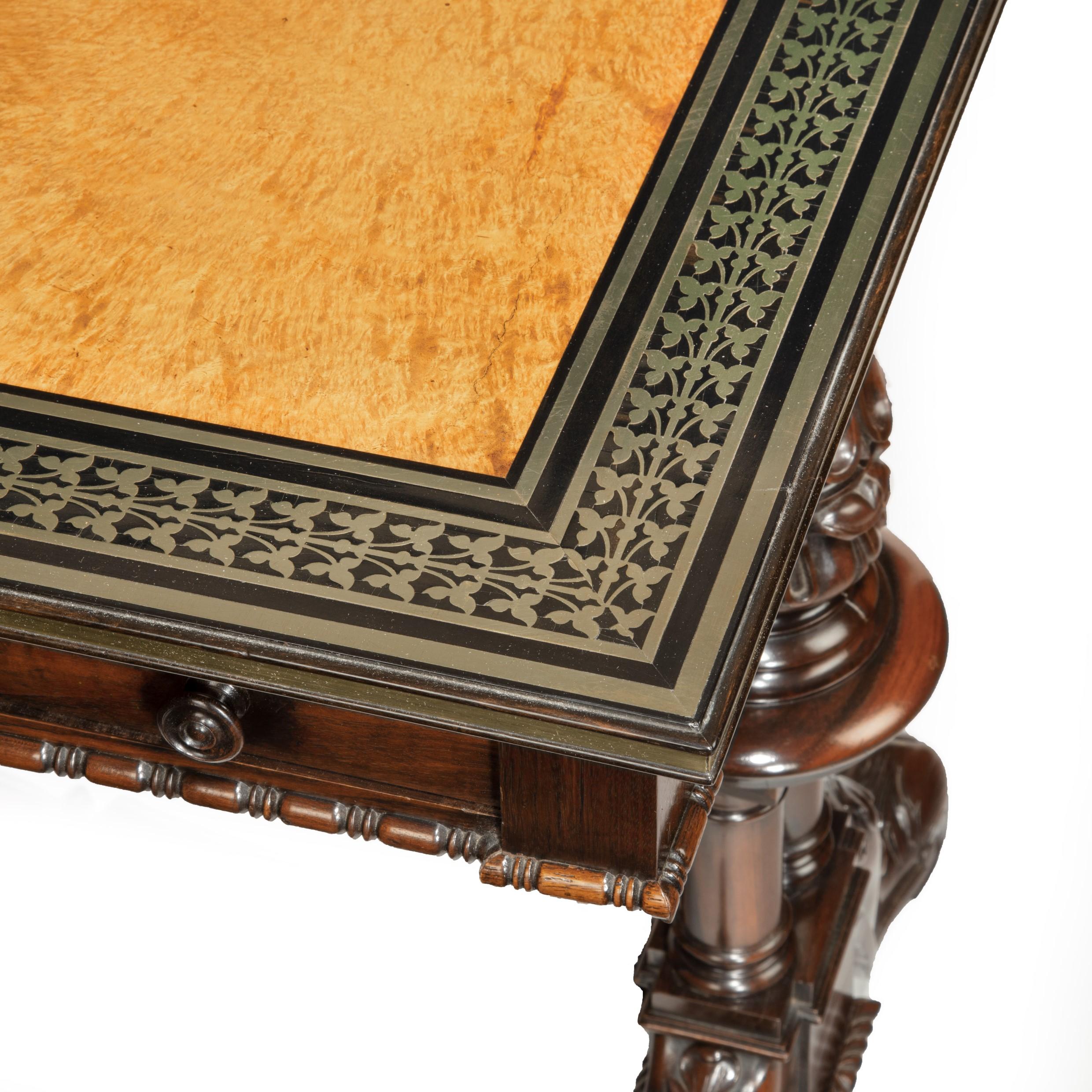 A striking Goncalo Alves (Albuera wood) writing table attributed to Gillows and Bullock, the rectangular leather-inset top with a wide band of paired ivy leaves and double borders in brass boulle-work inlaid into ebony probably by George Bullock,