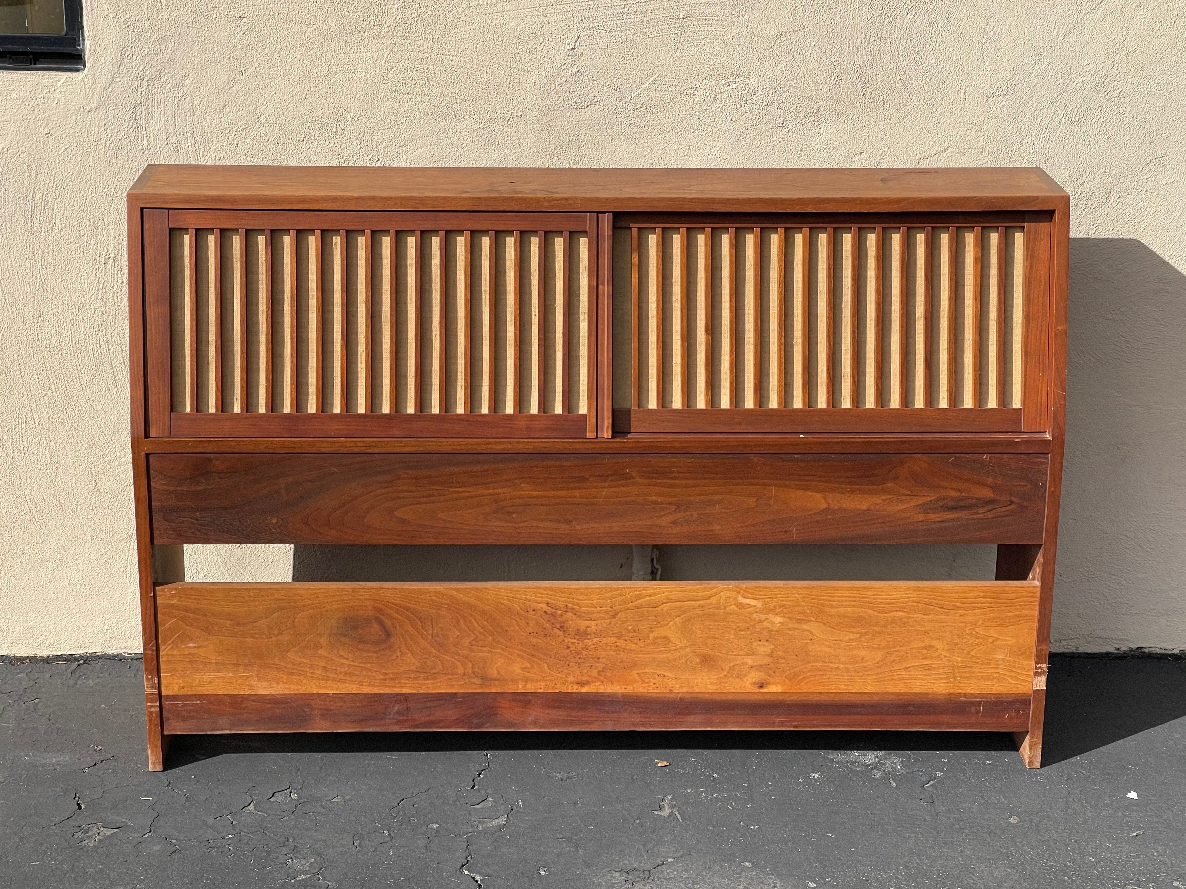 A striking handcrafted full size storage headboard in walnut by George Nakashima with paperwork, circa 1959. I will used Nakashima's own words as written on the receipt for further description of the piece: 