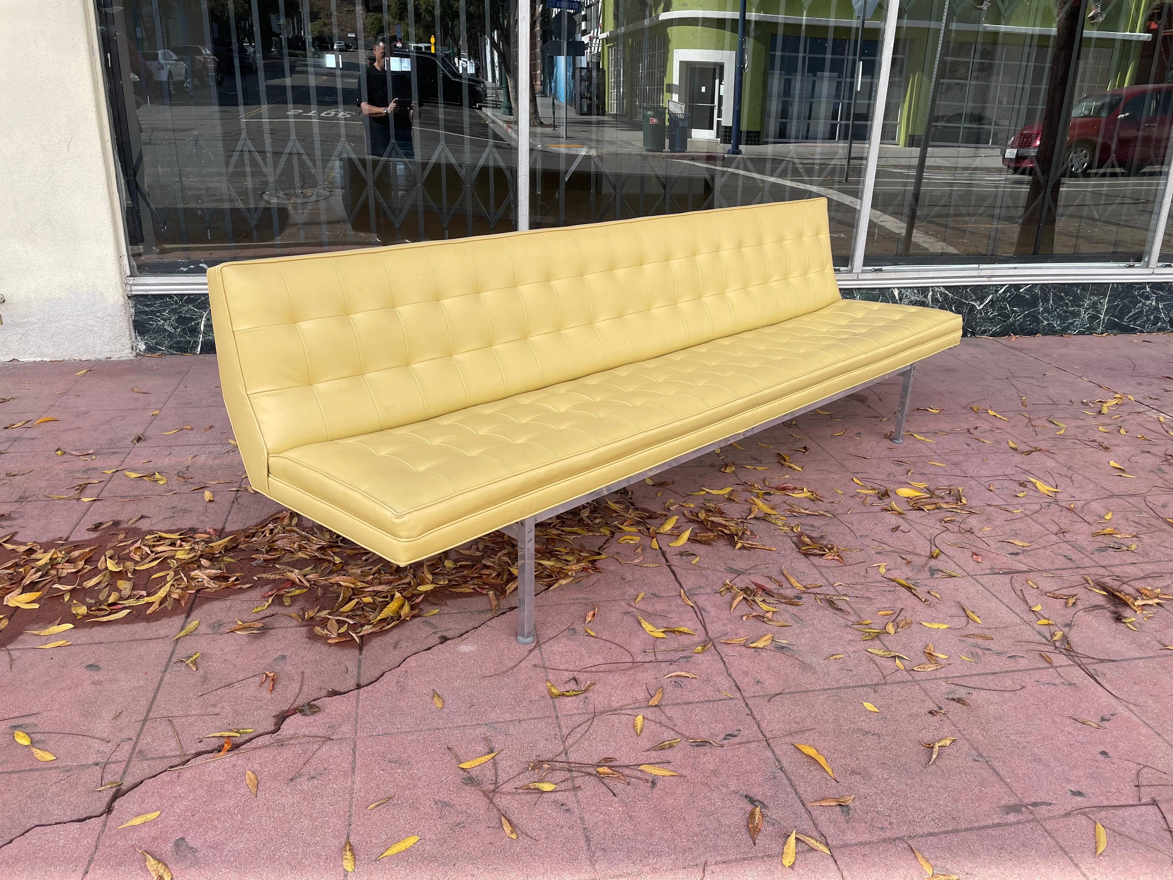 Beautiful and in its original condition armless sofa in the style of Knoll, circa 1950s simply elegant and in great condition considering the age great lines and design, with square aluminum polished pipping. Nice color and quality.