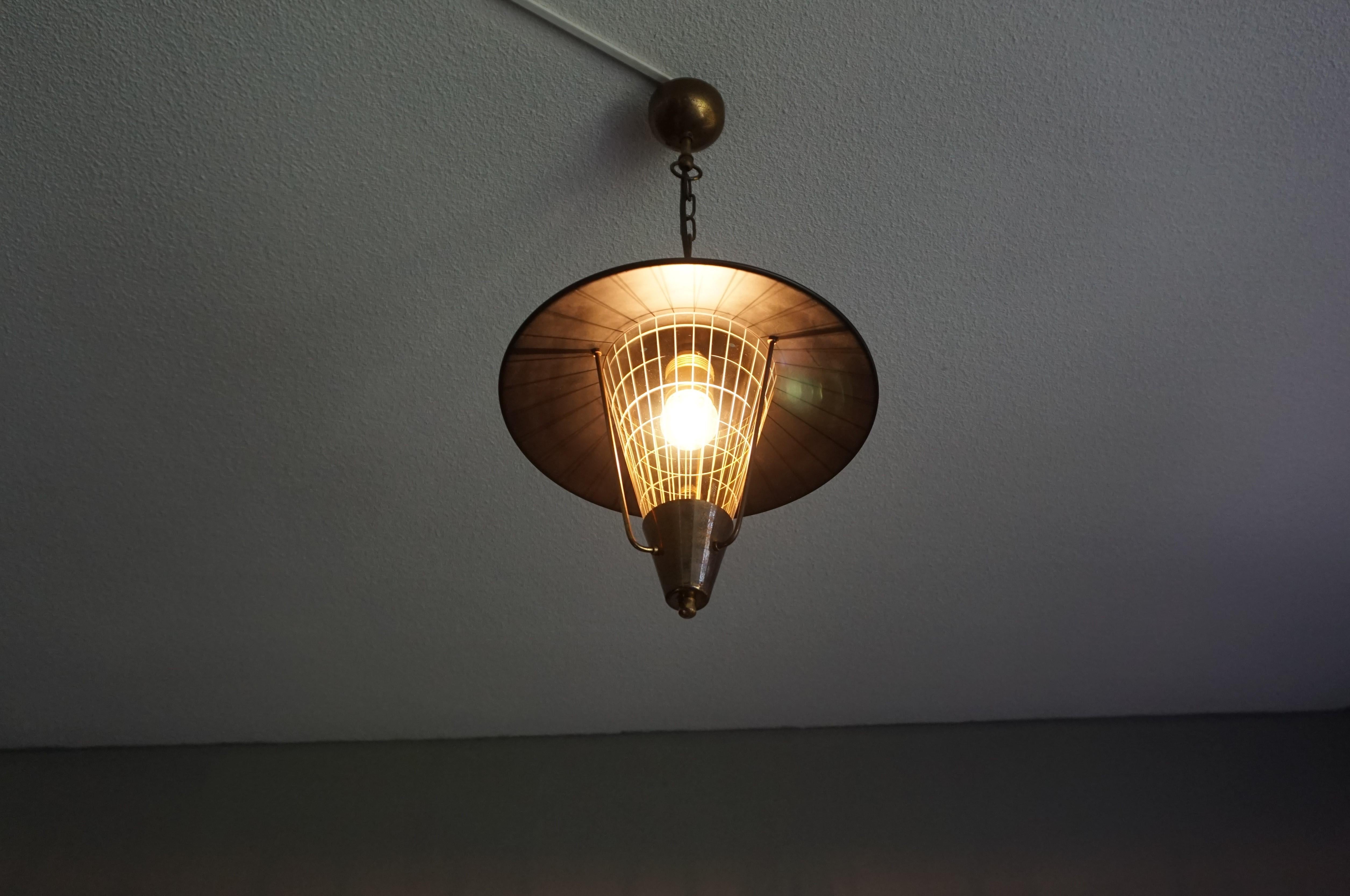 Superb condition and beautiful, midcentury modernist ceiling lamp.

We don't know which designer created this midcentury work of lighting art, but we can see why this unique fixture would perfectly complement the interior of a mid-century hallway,