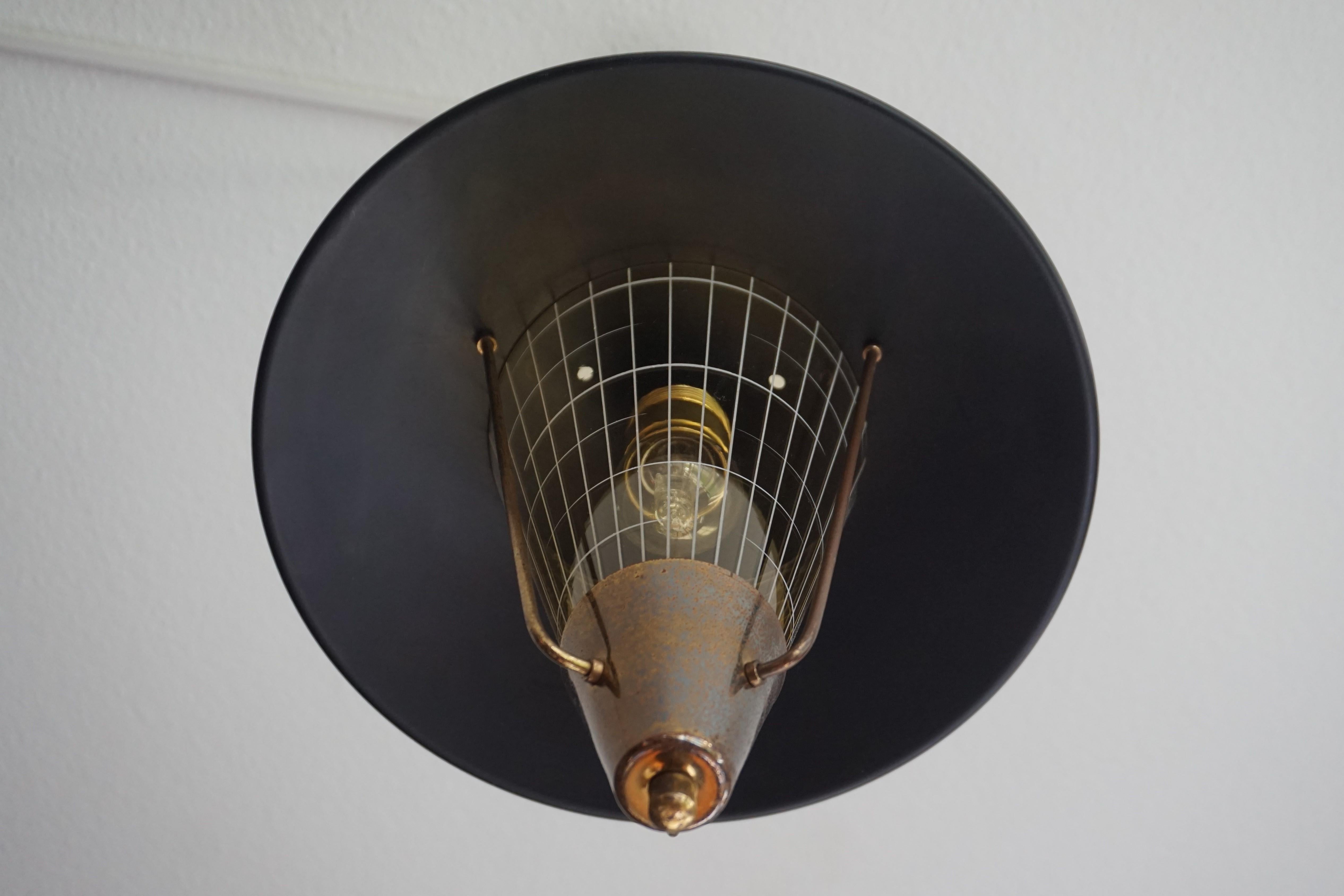 European Striking Mid-Century Modern Pendant Light w. Engraved Amber Glass in Brass Frame For Sale