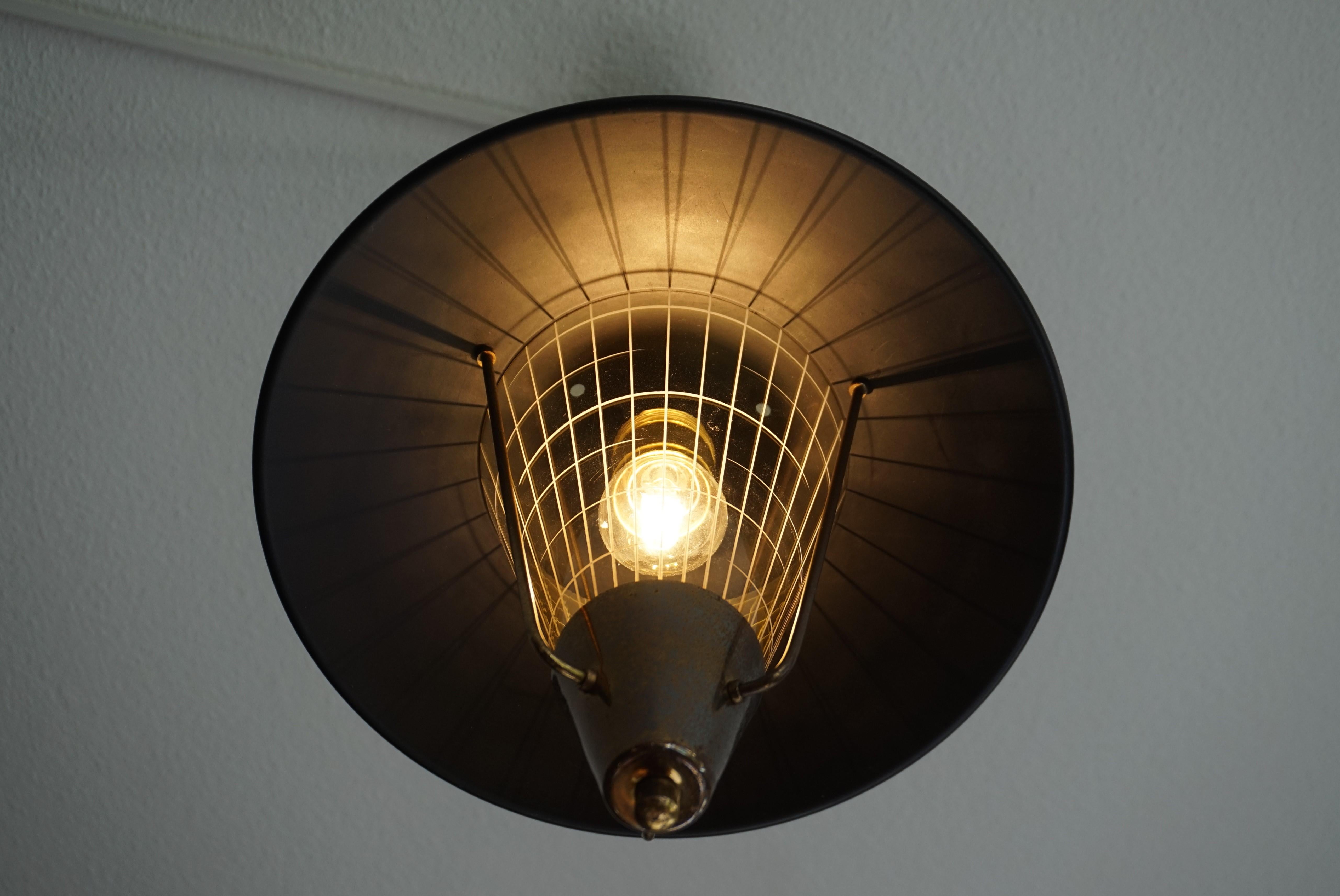 Blackened Striking Mid-Century Modern Pendant Light w. Engraved Amber Glass in Brass Frame For Sale