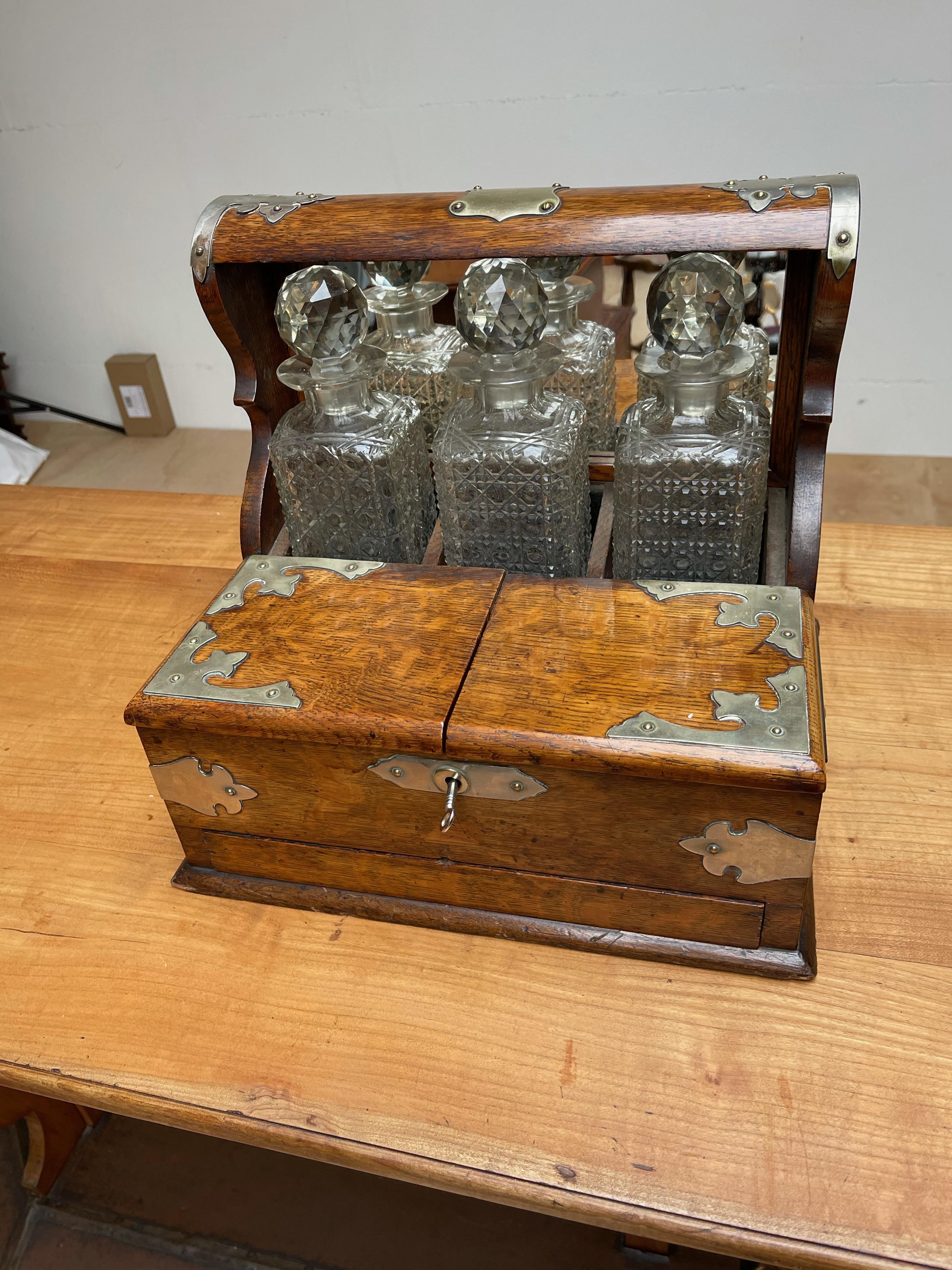 Good size and rare design, antique tantalus

This amazing condition and rare, three crystal bottles holding, tiger oak tantalus will look great everywhere. This handcrafted work of beauty dates from the early 1900s and it comes with two folding