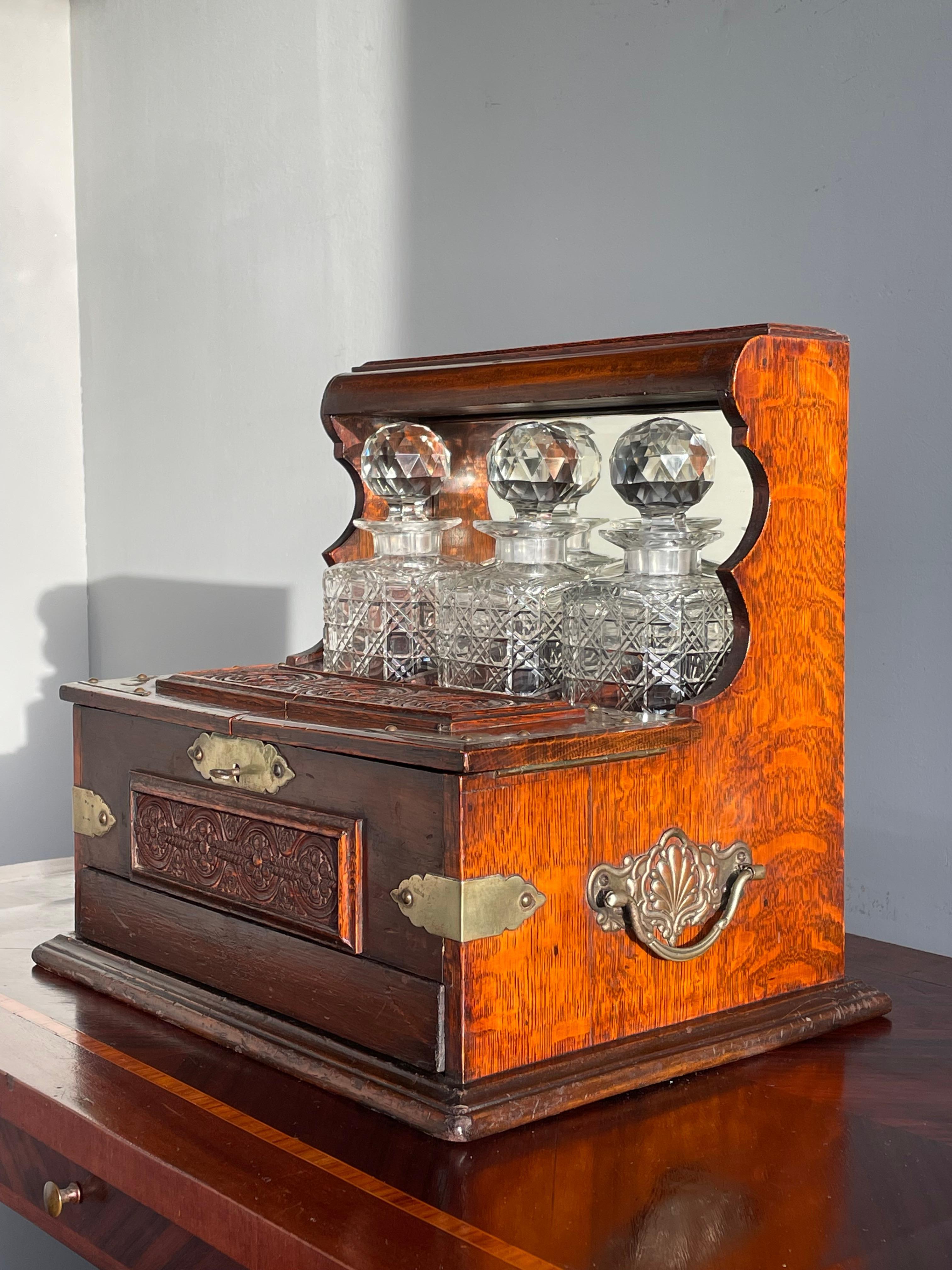 Large size and great design, antique tantalus.

This wonderful condition and rare, three crystal bottles holding, tiger oak tantalus will look great everywhere. This handcrafted work of beauty dates from the late 1800s and it comes with a variety