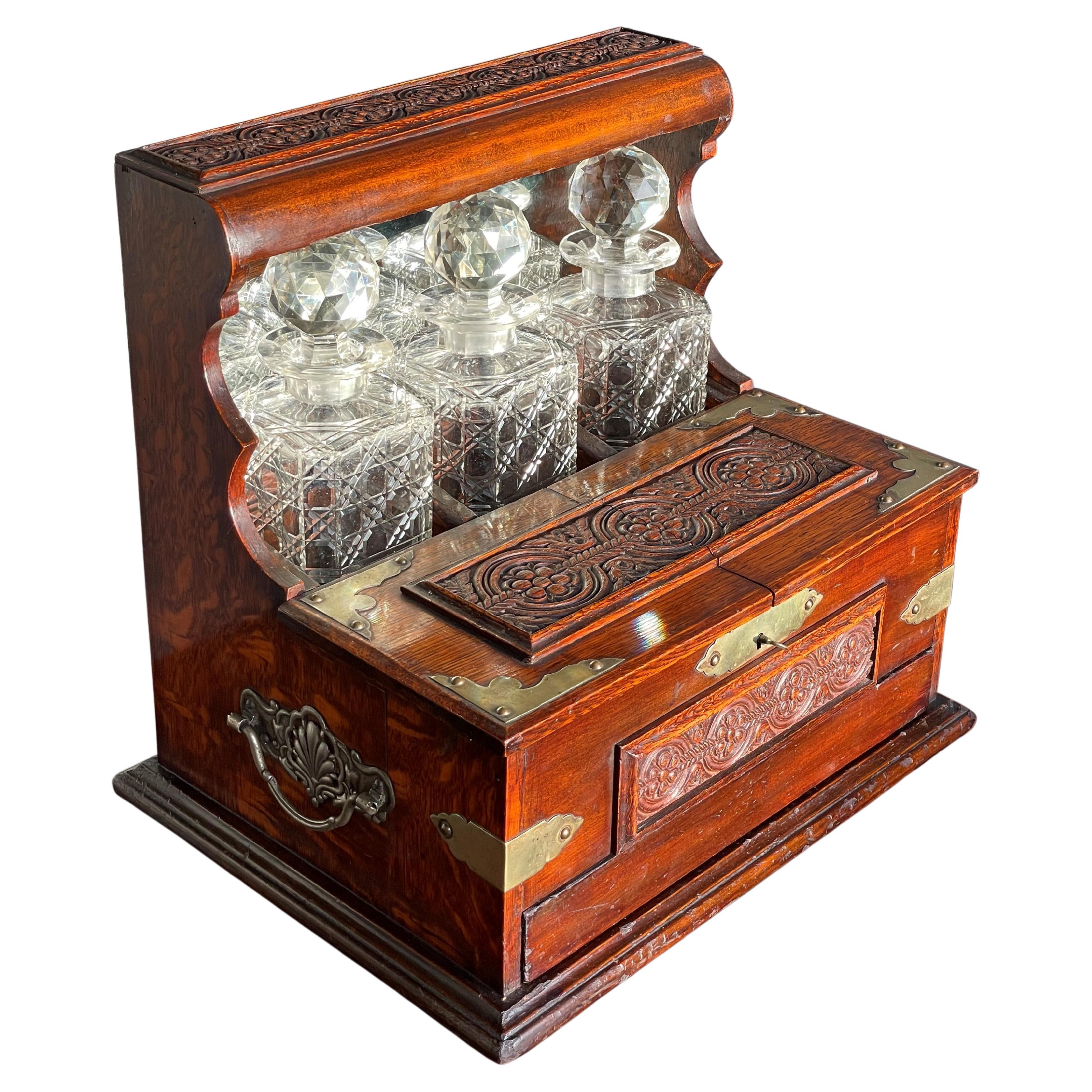 Striking Oak & Brass Tantalus with Whiskey or Liqueur Crystal Decanters & Drawer For Sale