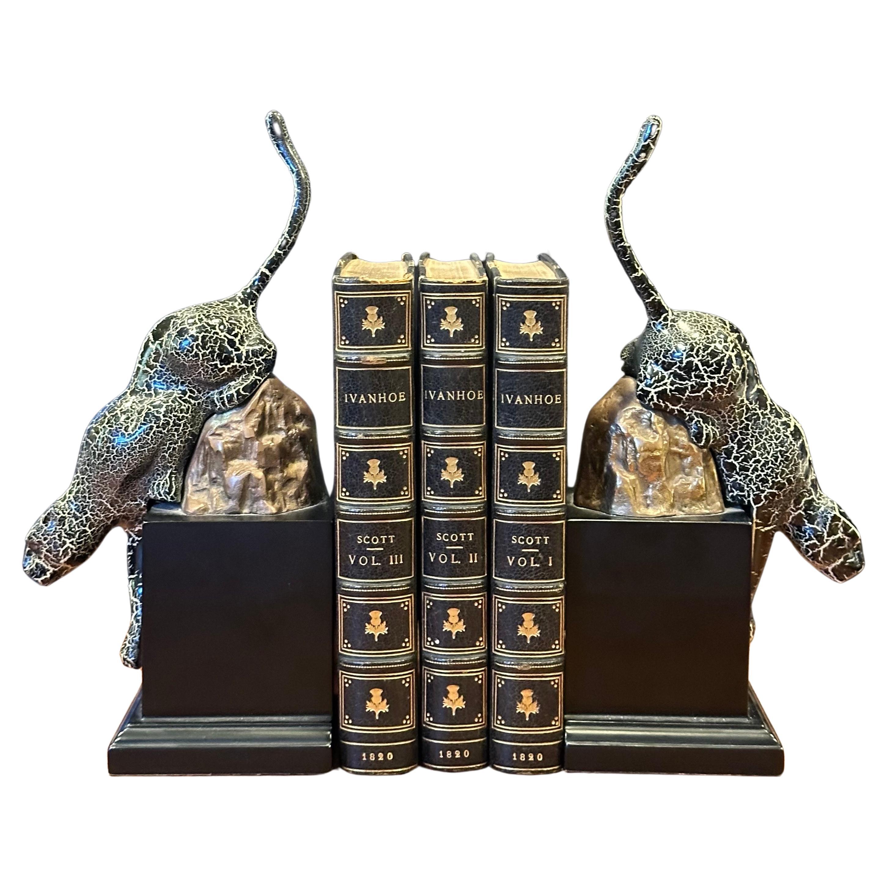 Gorgeous pair of brass and enamel art deco style jaguar bookends on wood bases, circa 1980s.  The bookends are in very good vintage condition, measure 10.5