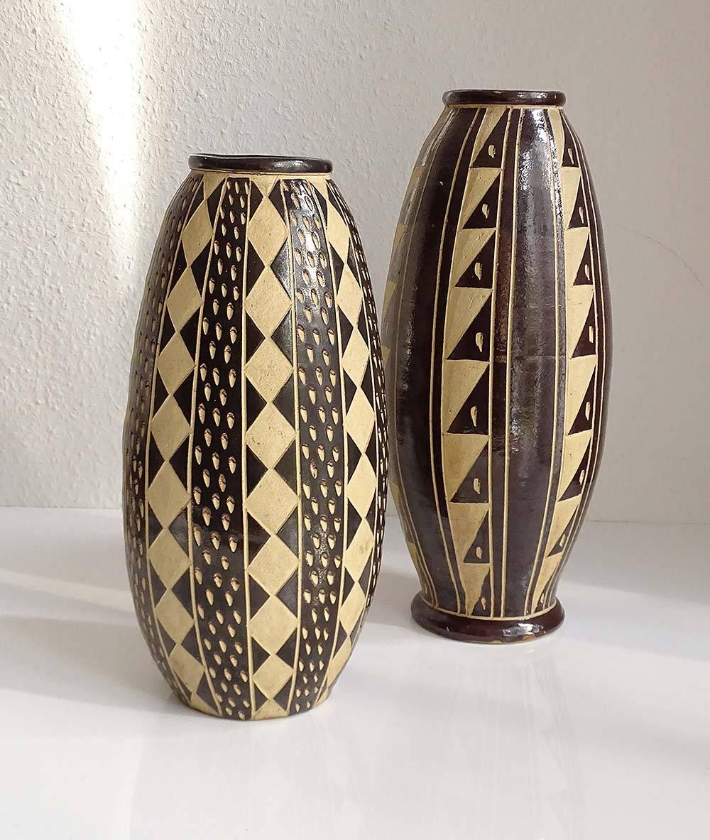 Pair of large Mid-Century ceramic vase, 1960s
Brown and white textured glaze with incised sgraffito abstract patterns
Marked on bottom with numbers 400/ 35 and 40a / 40
40 / 36 cm H x 15.75 / 14.15 in H
20 / 18 cm W x 7.87 / 7.08 W.

 