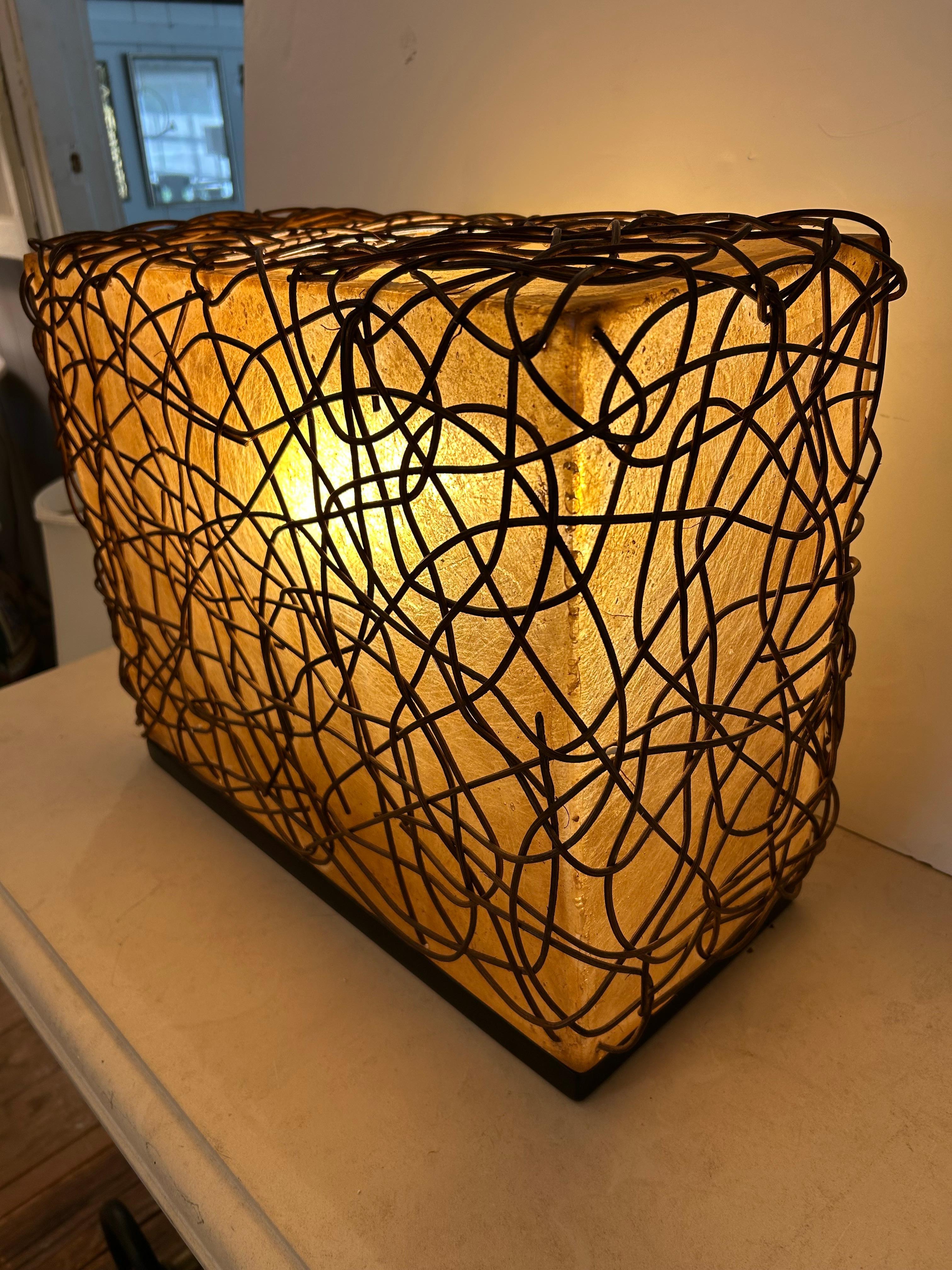 Unusual and super cool pair of rectangular box shaped organic modern table lamps hand made in Indonesia from tree resin and having web of twigs embellishing the body of the lamp.  Takes one 60 w bulb.  Sculptural and vibey!


