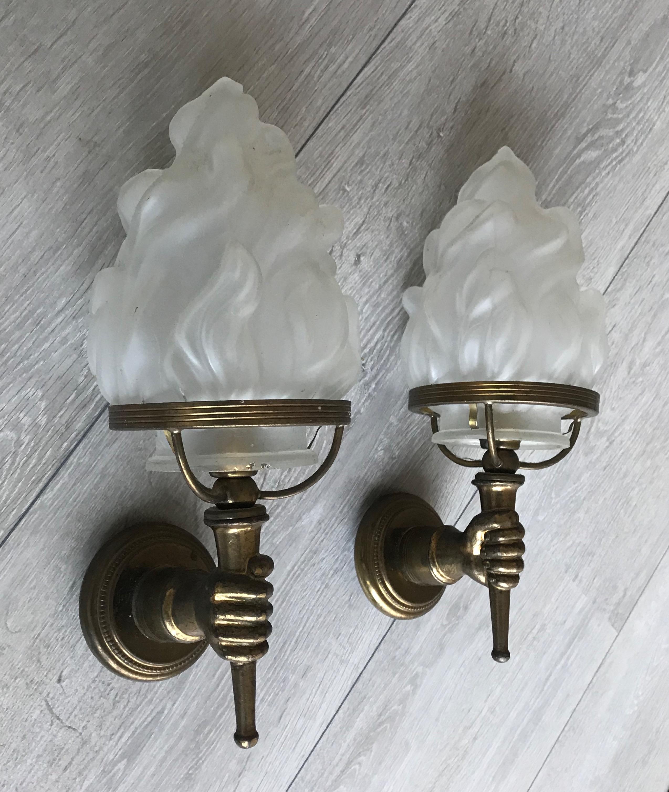 Midcentury hands-holding-torches wall lamps.

If you are looking for a small and decorative pair of wall sconces then look no further. These stylish and sought after, brass wall sconces could make the perfect wall lights over your nightstands, on