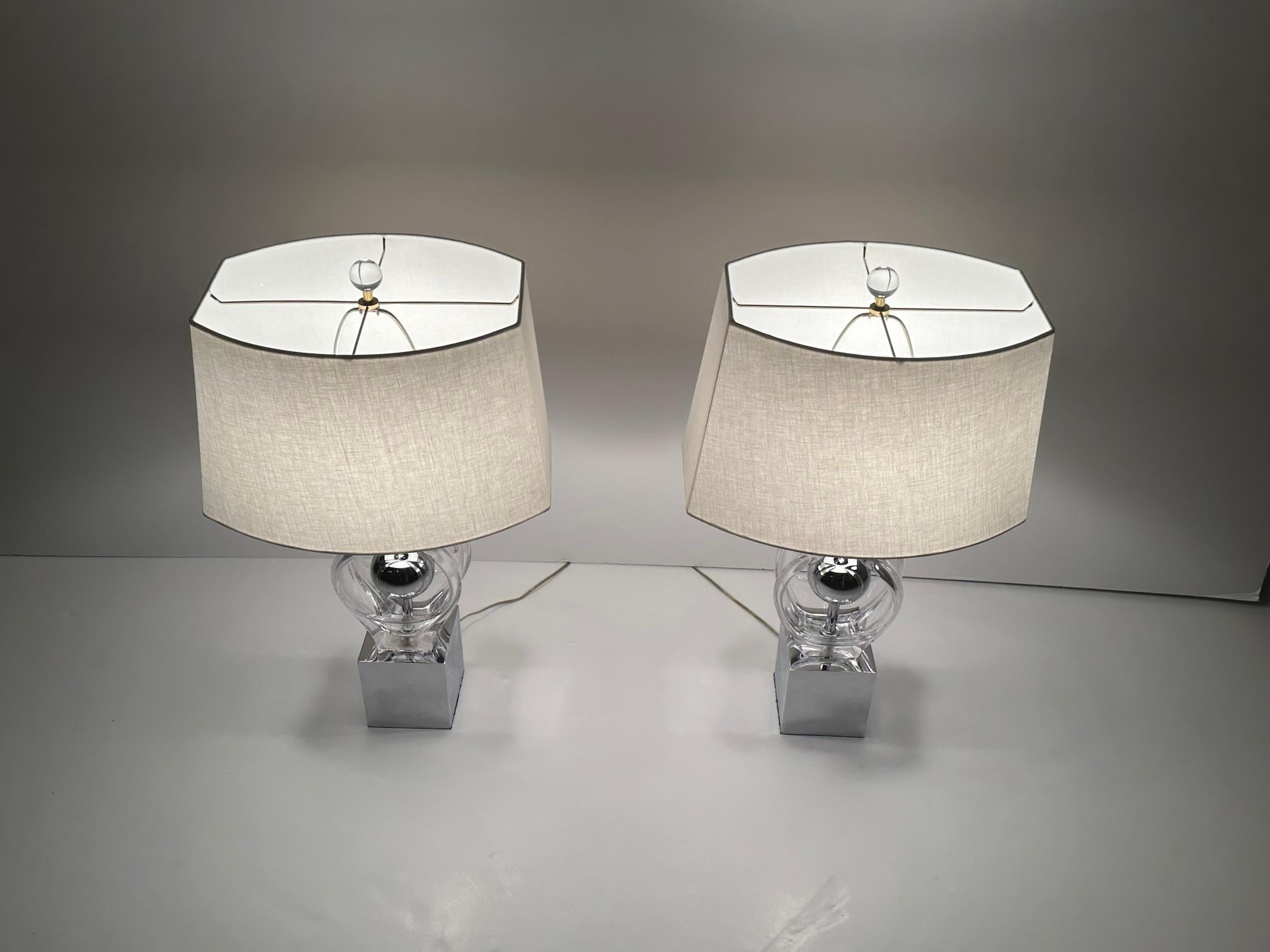 Super chic pair of glass and chrome mid century modern table lamps having chrome bases with round silver chrome ball and sculptural glass on each side of central spheres.  
20.5 h to top of socket