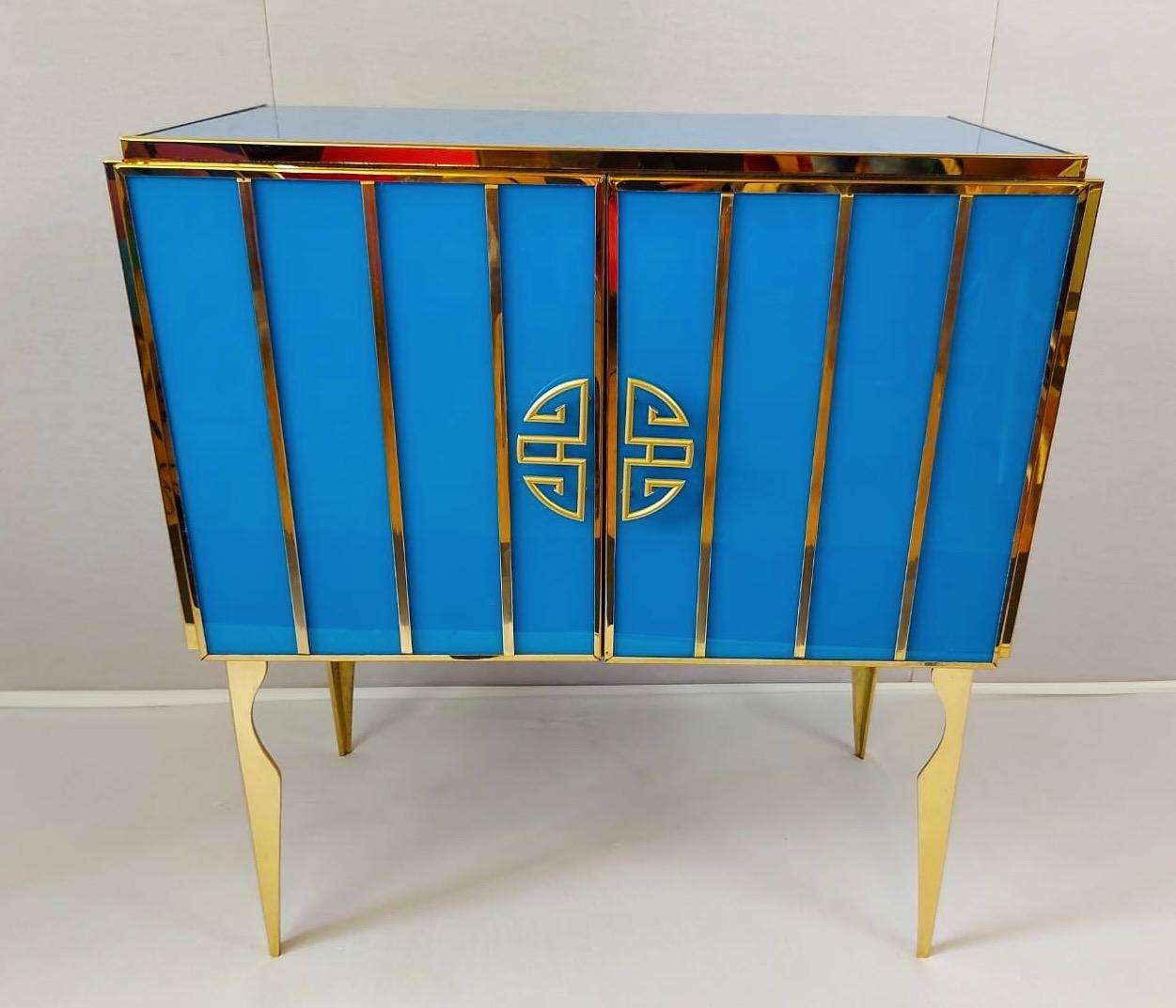 He and she pair of very fine handmade Cabinet by a master artisan. Brass frame with handmade and handcut cobalt blue and white opaline Murano glass raised on special brass legs.
Offered separately or as a pair. Listed price is for custom made pair.