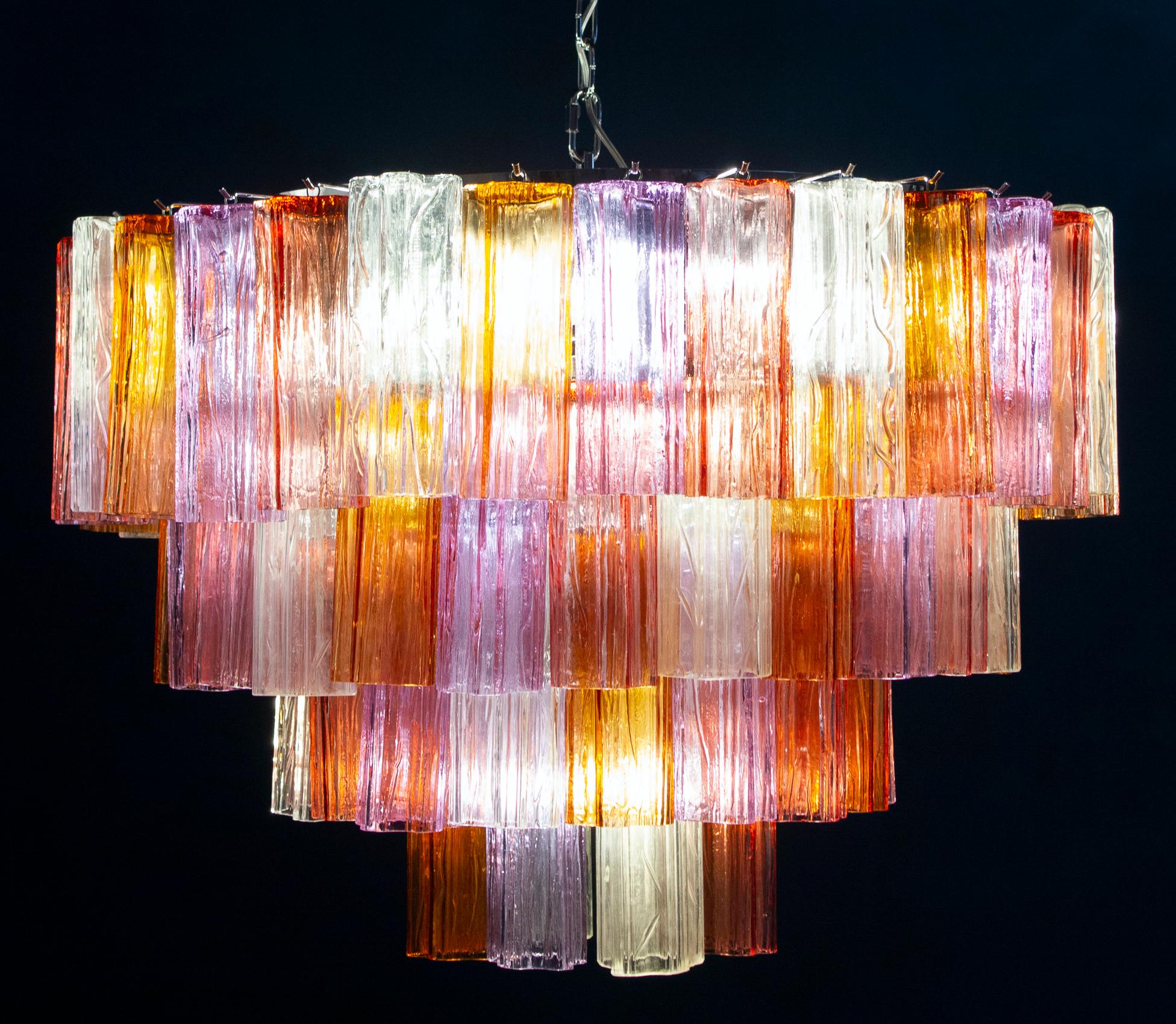 Pair of amazing chandelier with rare color combination considering the uniqueness with amber, pink, amethyst, and ice color precious Murano glasses. Each chandelier with 78 glass blown tronchi elements supported by a chrome frame.
10 E 27 light