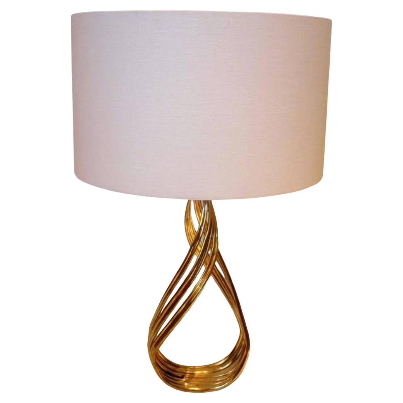 Great and unique pair of solid patinated bronze twisted bases sitting on solid Lucite base, the lamps are rewired,  new sockets and new white linen lampshades with Lucite finials, these lamps are incredible circa 1970s, in great condition, the lamp