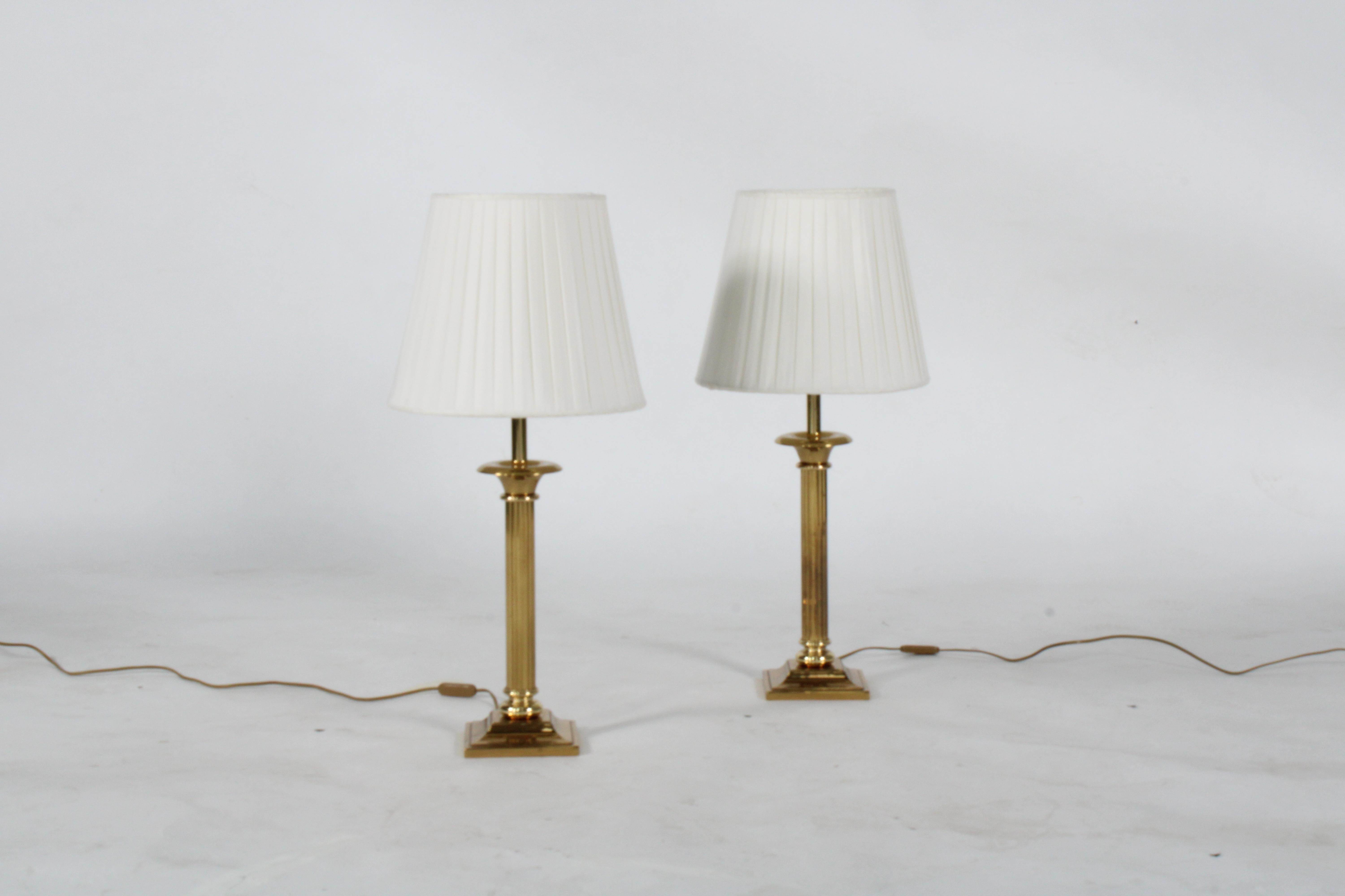 Striking pair of vintage brass plate table lamps in the form of a Corinthian columns with bespoke handmade shades. Presented in excellent vintage condition this stylish pair will look amazing in any private home or interior design project. Please