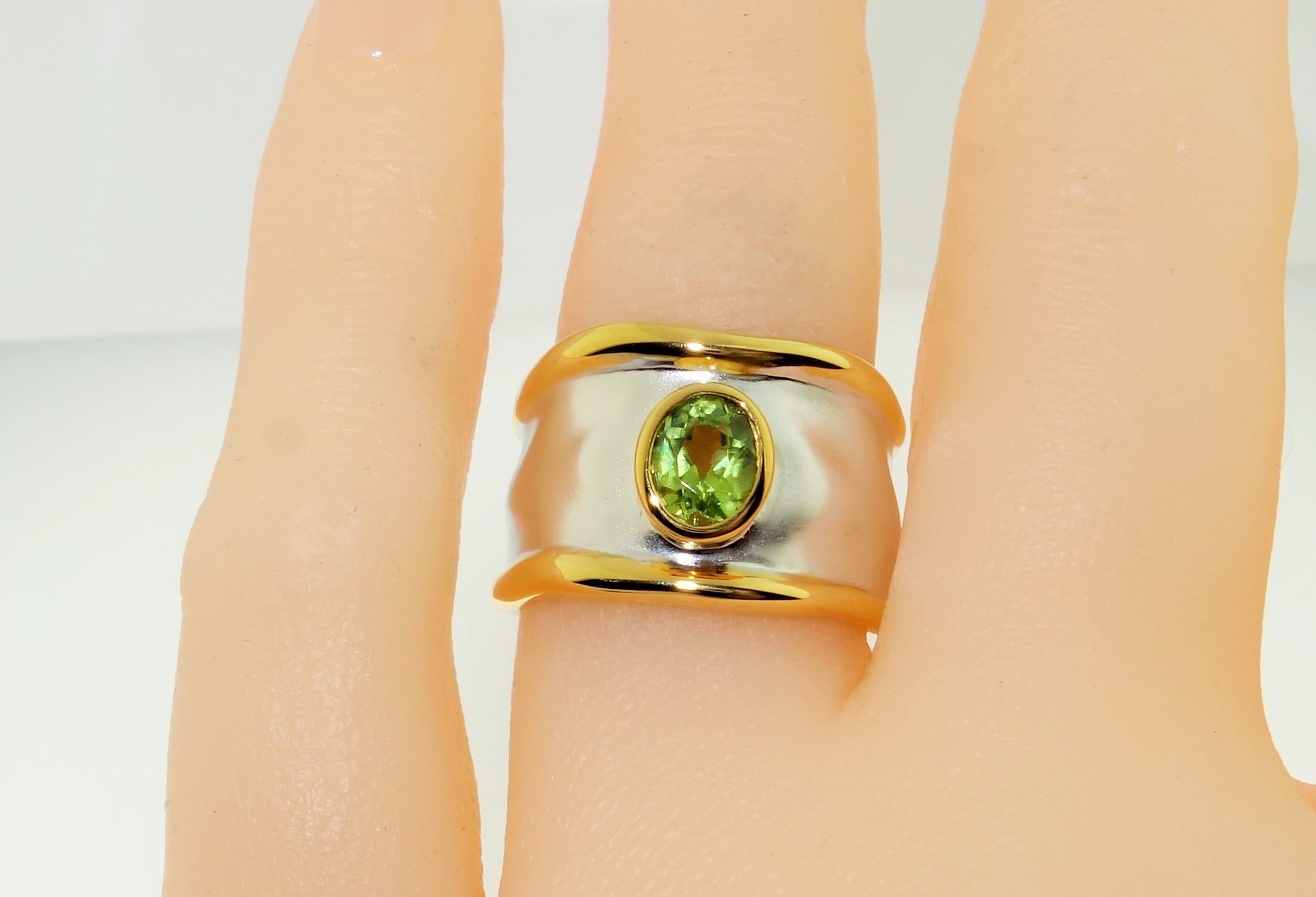 Beautiful solitaire ring featuring an oval Peridot; approx. 0.75 carat; approx. stone size: 6mm x 5mm. Sterling Silver Tarnish-resistant Rhodium and gold accents on either side of mounting. Size 6. Classic and Chic…illuminating your look with