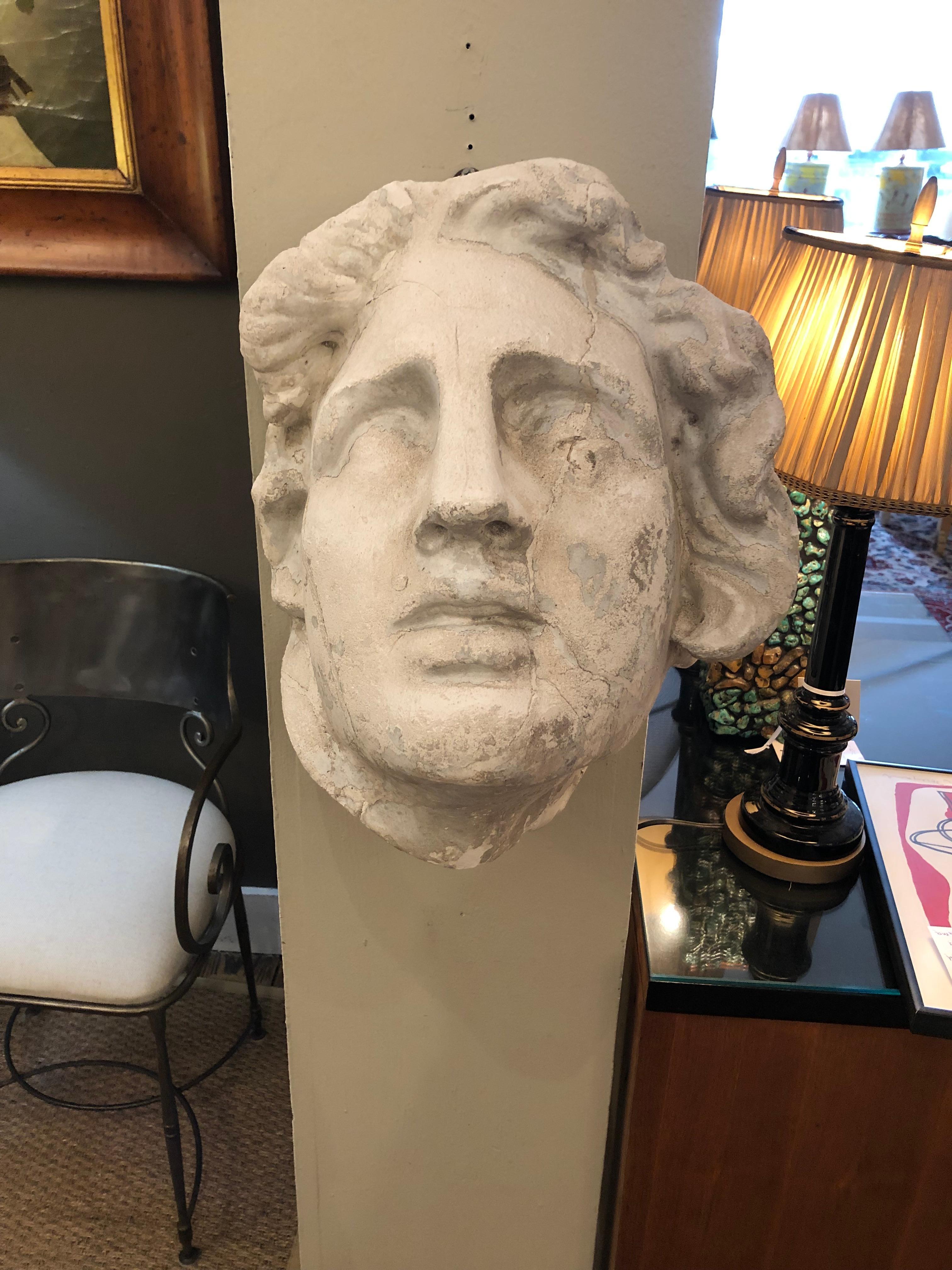 Striking large plaster 3-D wall sculpture of a neoclassical style head, perhaps of Apollo or other God with handsome chiseled physiognamy.
 