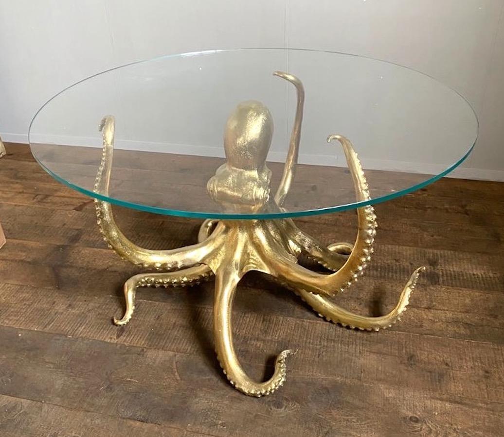 Modern gilt bronze dining or center table in the shape of an octopus.
The glass top can be custom-made on request. 
 Dimensions of the sculpture is height 77 cm diameter 115 cm.
Glass top diameter 140 cm.

