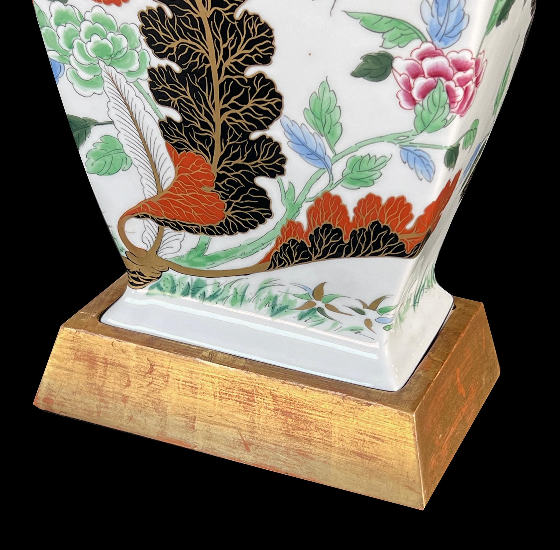 from the Vista Alegre Porcelain Factory (founded 1824) each rectilinear vase with flared neck above a tapering body ending in a splayed foot; hand decorated overall with vibrant floral and foliate vines; maker's mark to underside; now drilled and