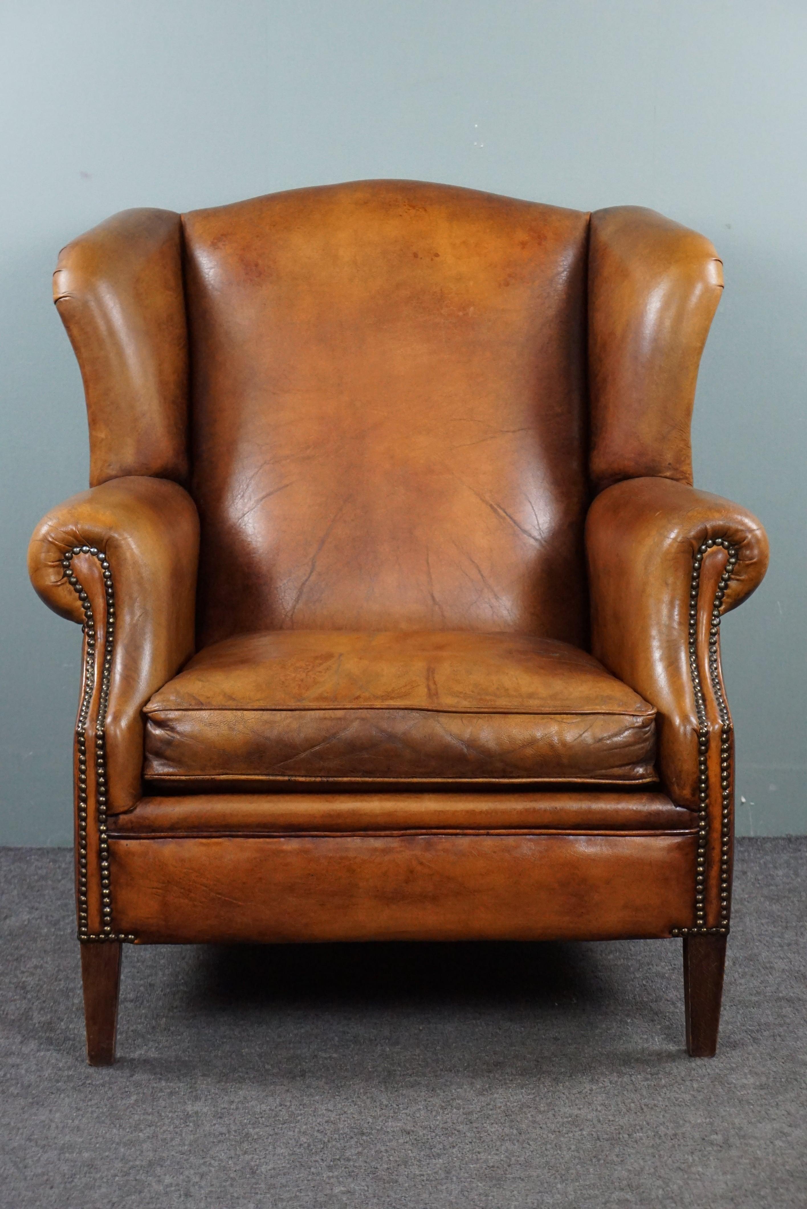 With pride, we present to you this beautifully warm-toned sheep leather wing chair, adorned with decorative nails all around, giving this wing chair both a timeless and sophisticated look.

The distinctive design enhances the beauty of the exquisite