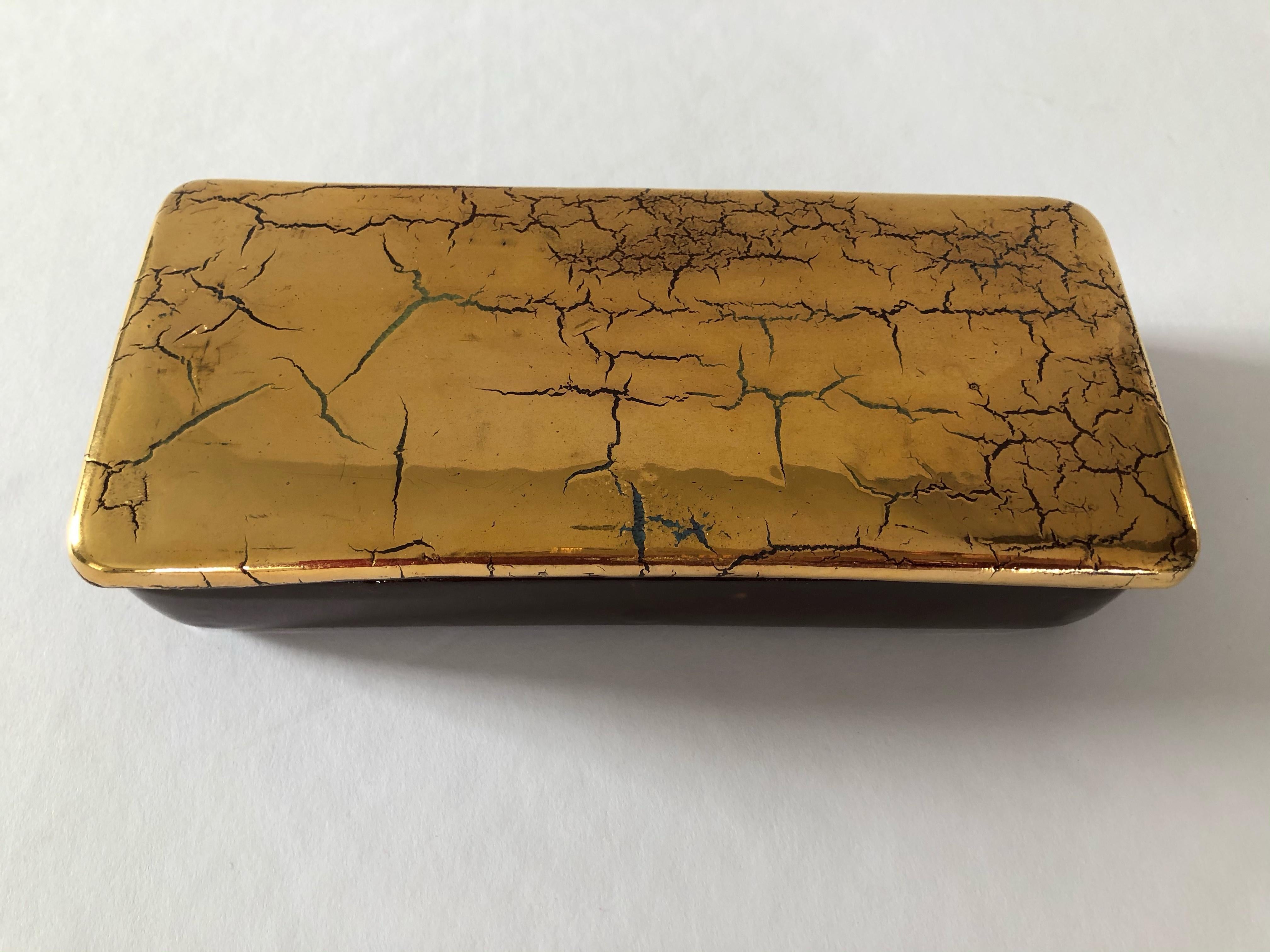 A striking Bitossi box from the 1960s in cracked gold. Made in Italy, the box has a brown glazed bottom and the top has a gold crackled glaze with wonderful patina. The gold glaze is a rare find.
