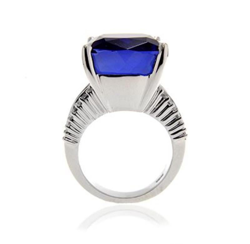18k White Gold 25.52ct Tanzanite amd 2.76ct Diamond Ring

This tremendous cushion Tanzanite benefits from the simple styling of a princess and baguette diamond band.
 Item: # 01512
Metal: 18k W
Color Weight: 25.52 ct.
Diamond Weight: 2.76 ct.
