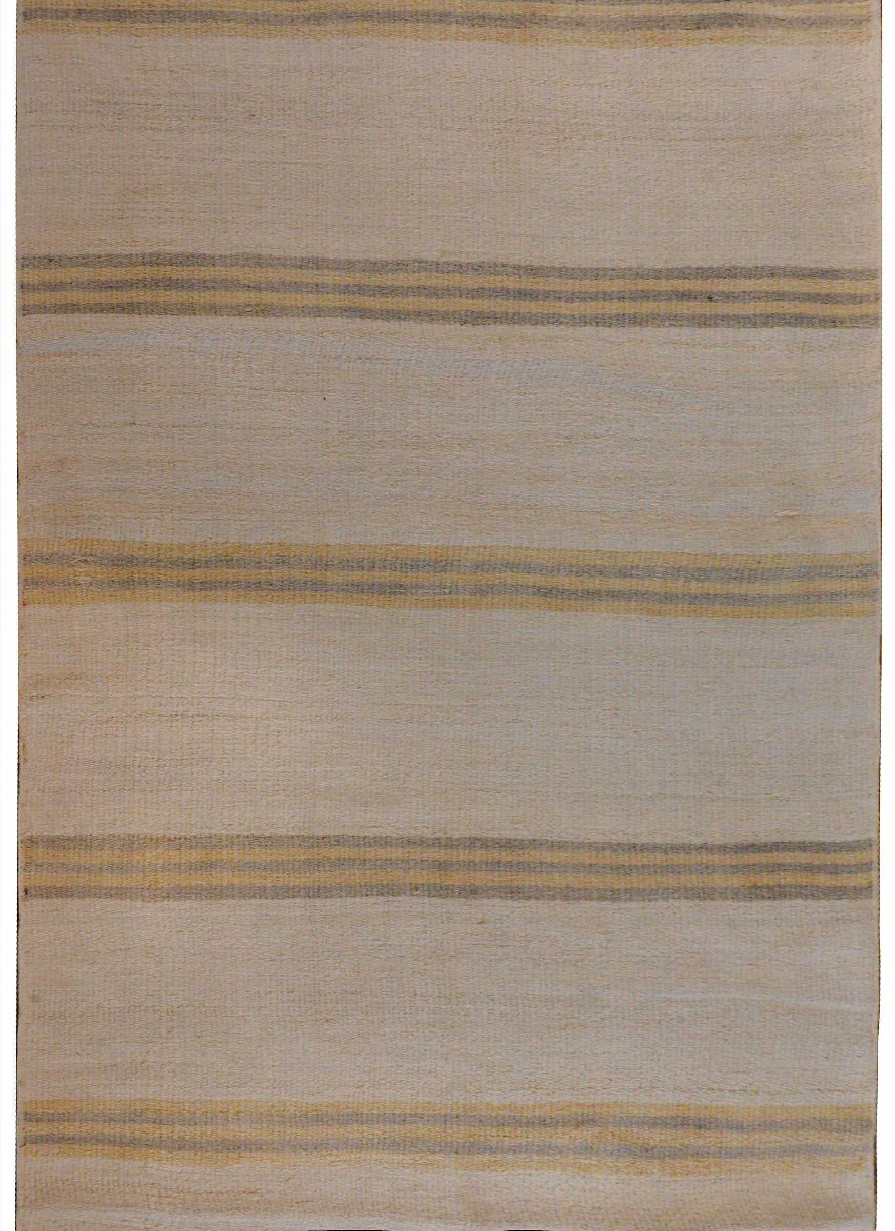 A striking vintage mid-20th century Turkish Konya Kilim runner with a gold and gray striped pattern on a cream colored background.